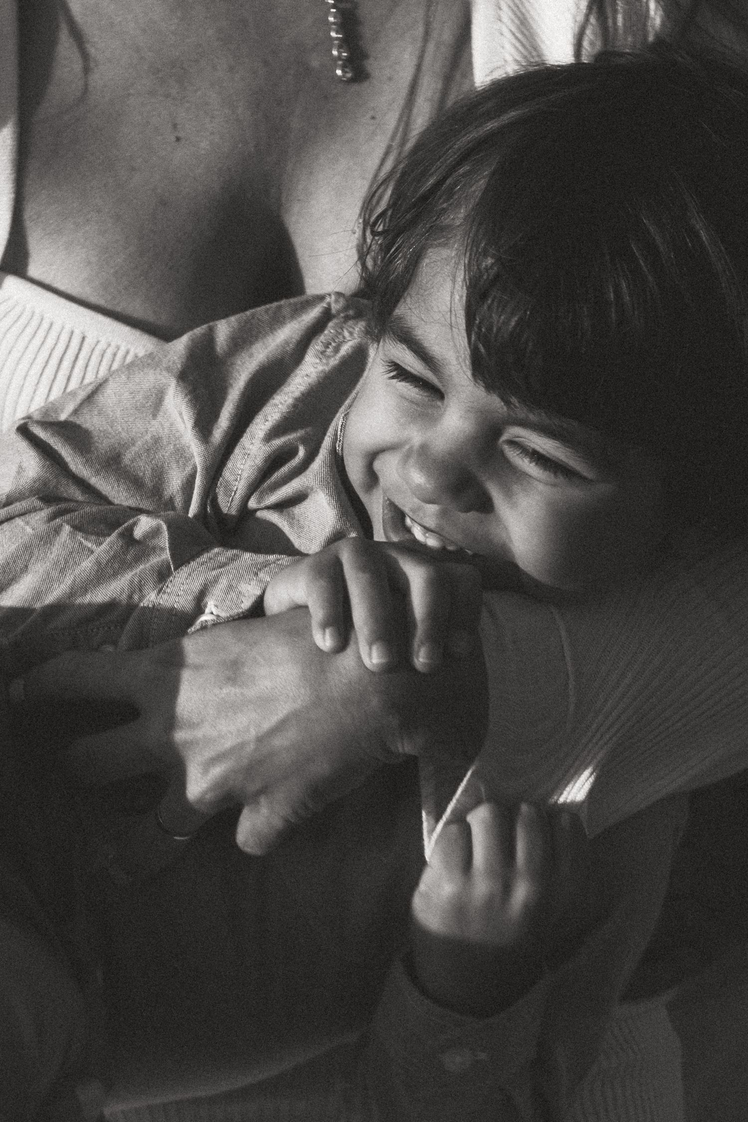 Black and white intimate photo sequence showing tender moments and laughter.