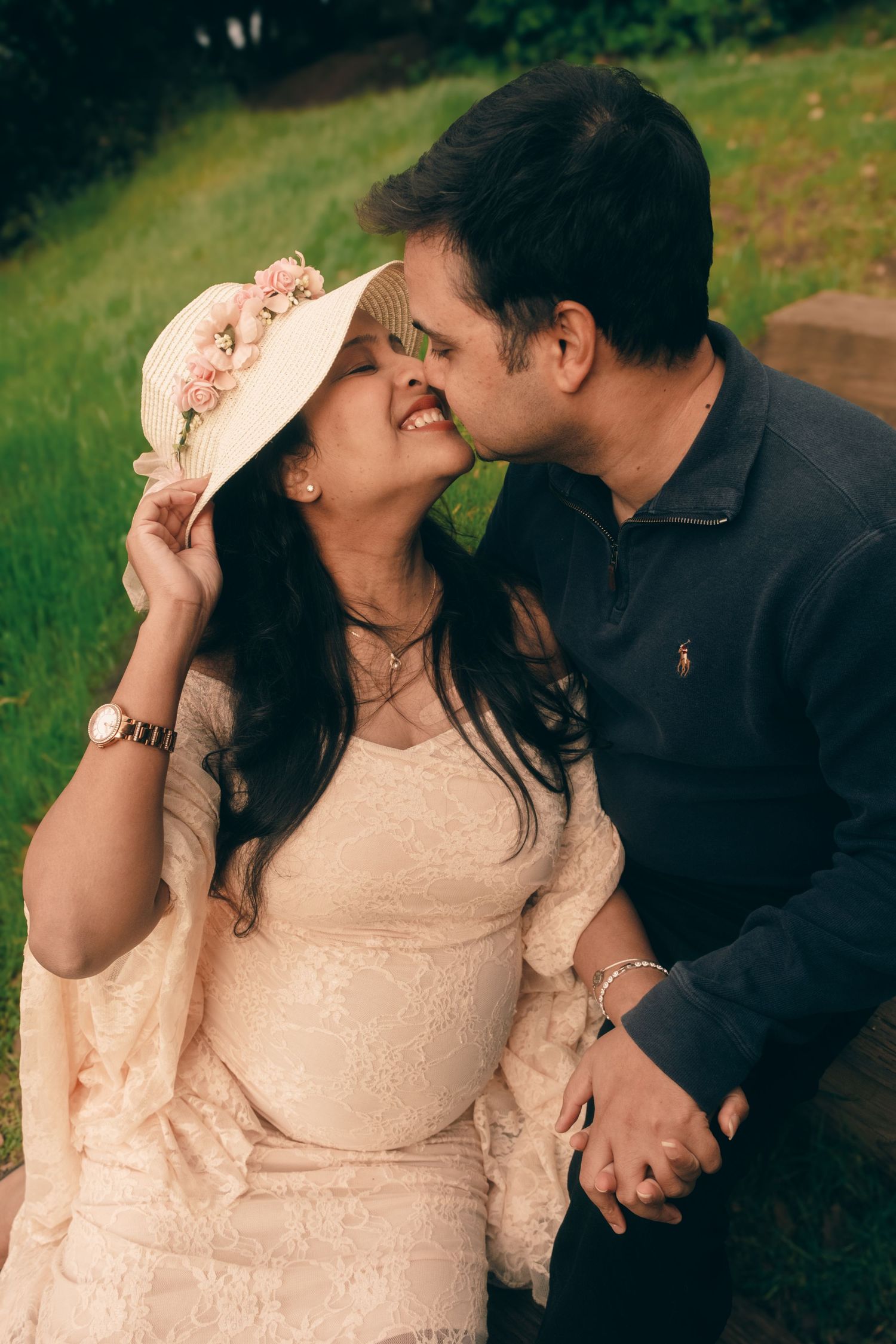 Intimate couple moment captured in outdoor setting with soft natural lighting.