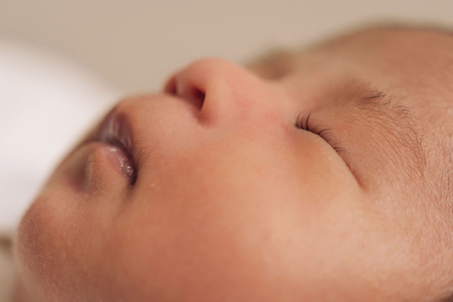 Close-up of a peaceful sleeping newborn baby with soft skin and delicate features.