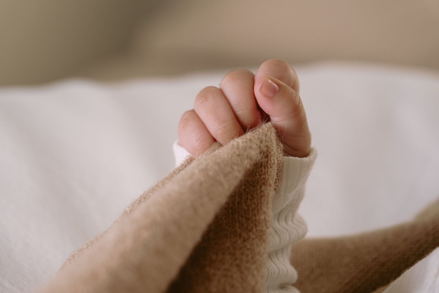 Soft focus detail shots of skin and fabric textures.