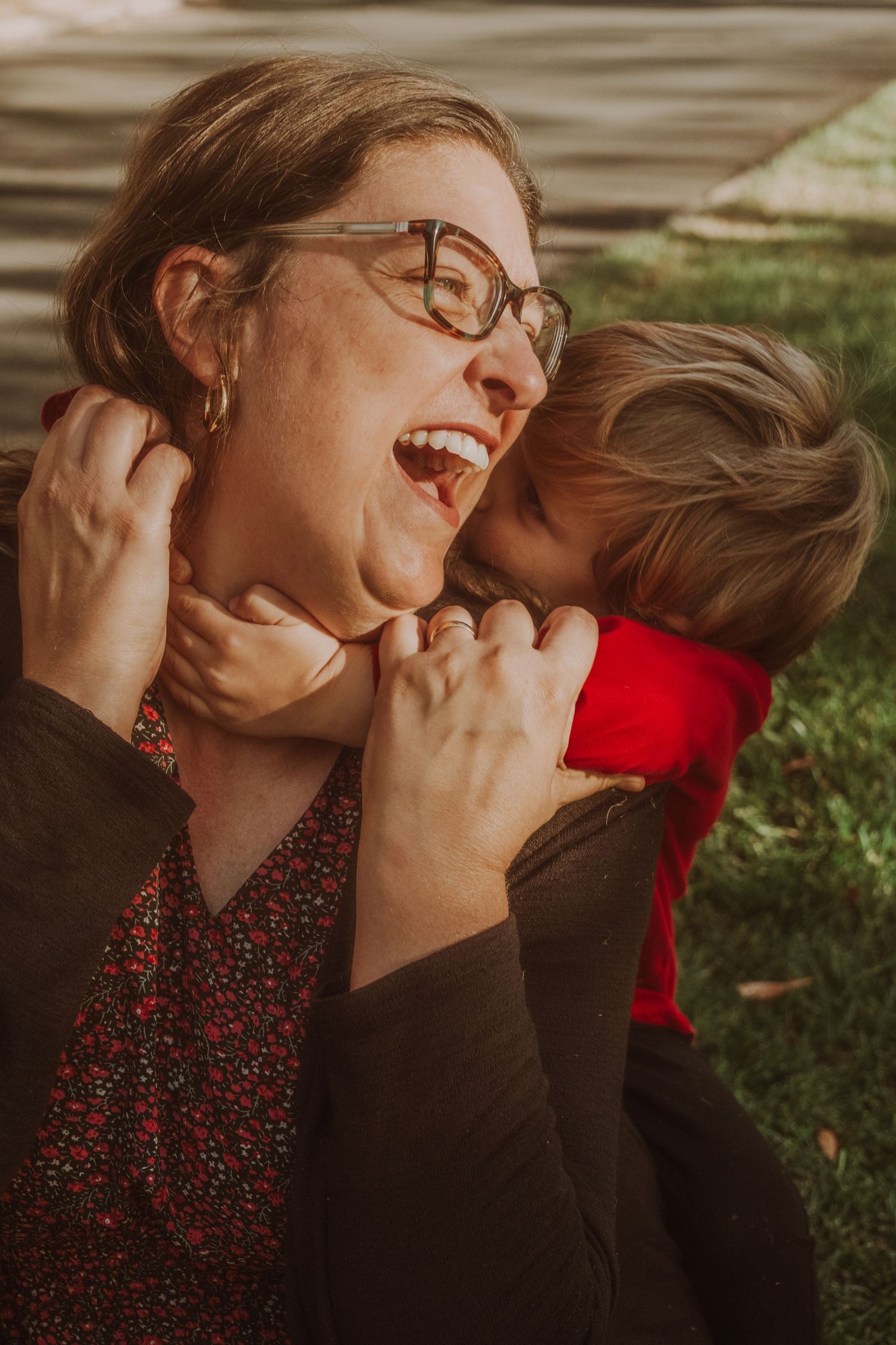 Candid moments of laughter and joy during an outdoor autumn photoshoot.