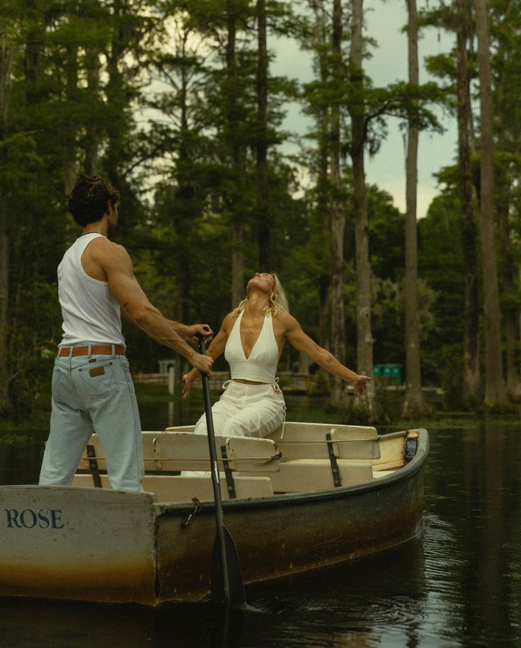 Wooden boat named Rose floating on tranquil waters surrounded by cypress trees.