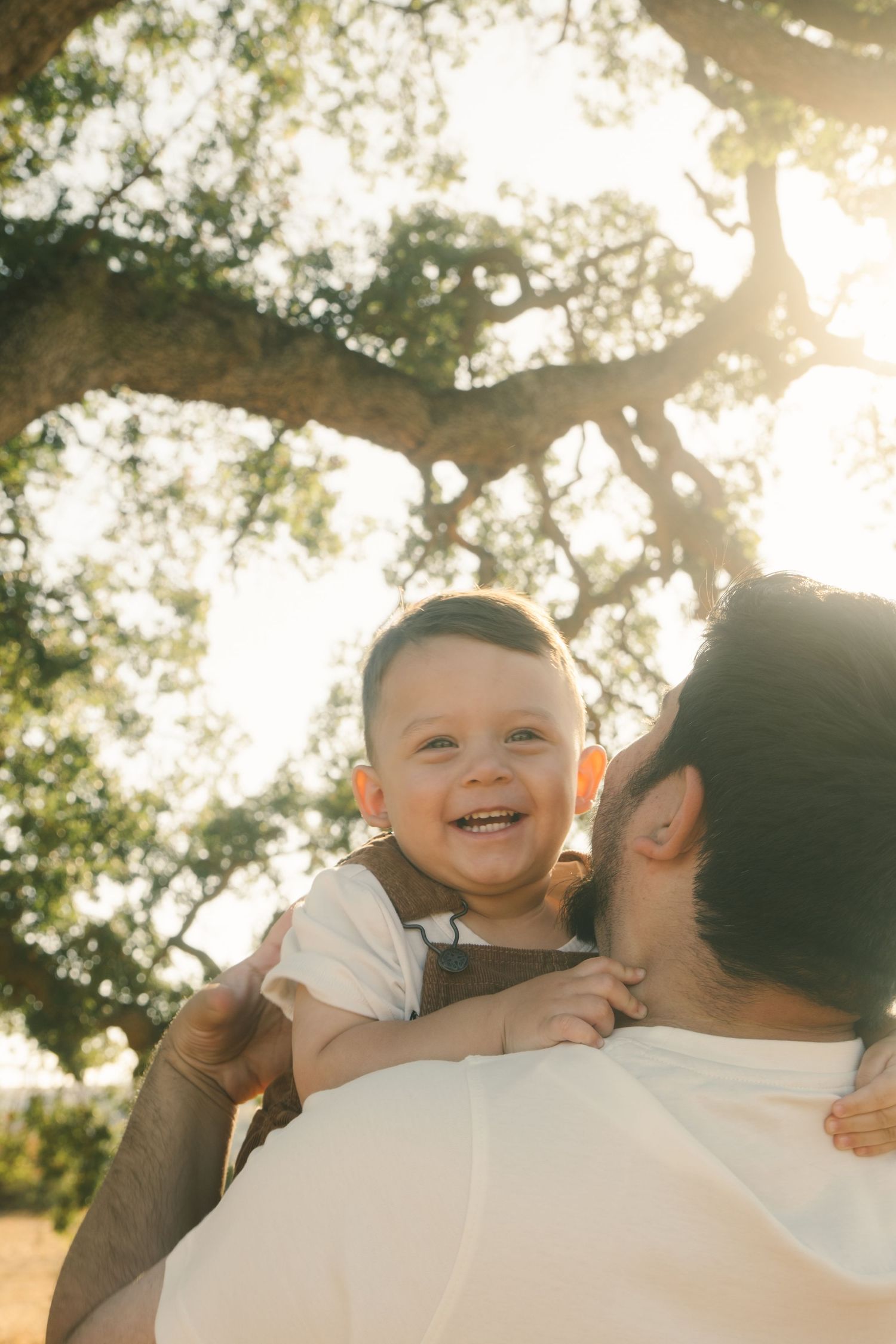 Heartwarming family moment captured in golden backlit setting.