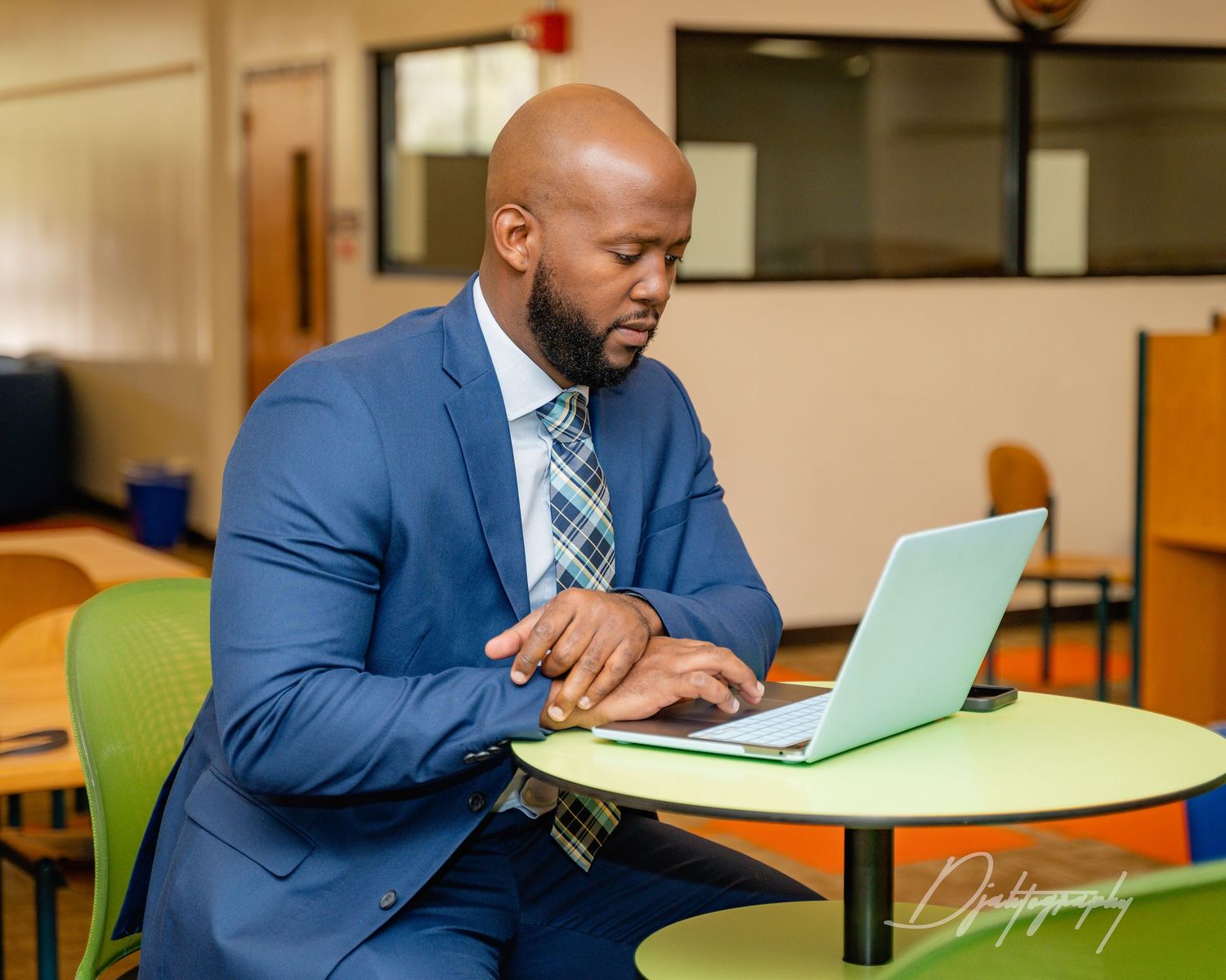 Business professional working on laptop, modern corporate branding photography session.