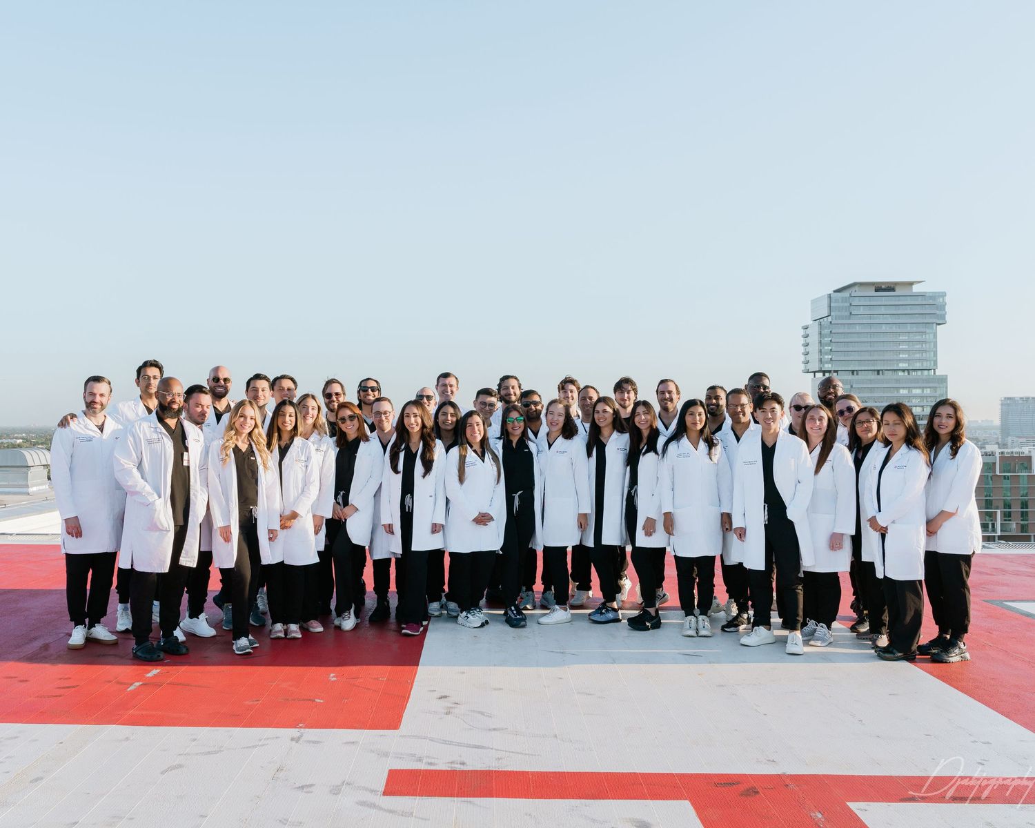 Large physician group photo South Florida medical professionals corporate team branding photography outdoor setting