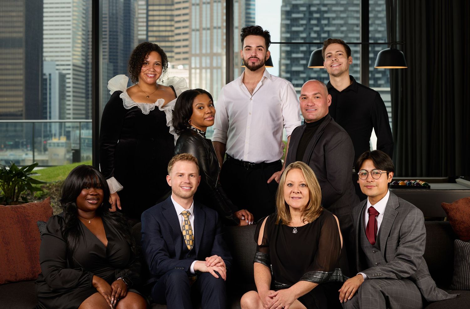 Business professionals gathered together in a corporate office setting for a group photo.