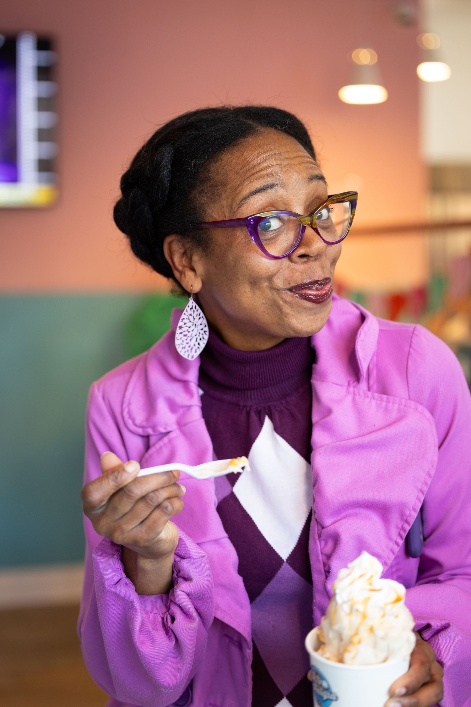 A sequence showing someone in a purple turtleneck and pink blazer enjoying popcorn with animated expressions.