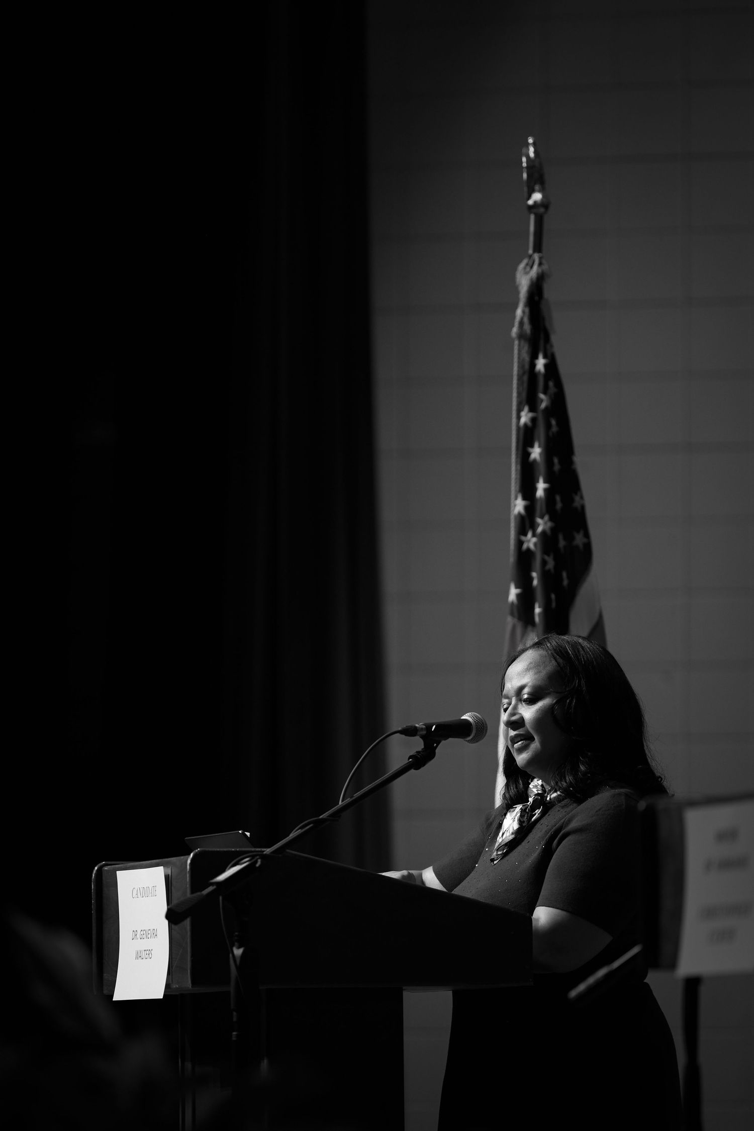 A dramatic black and white photo series showing a speaker at a podium with an American flag in the background.