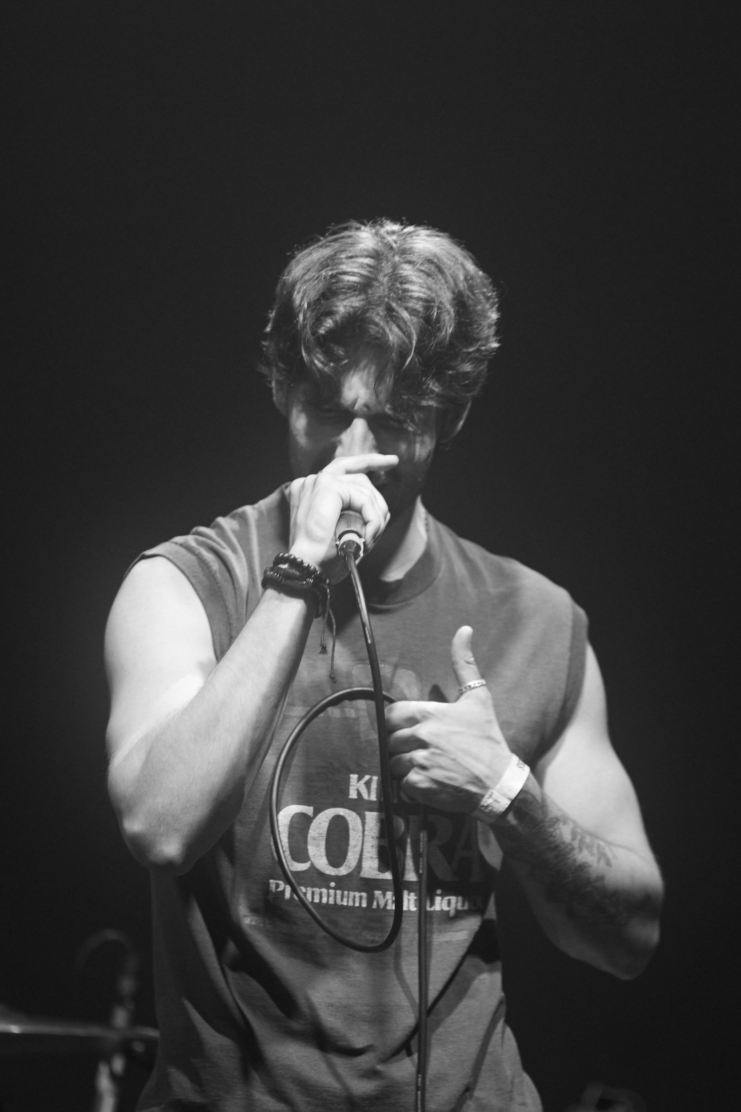 Black and white photo sequence showing a performer singing emotionally into a microphone during a live concert.