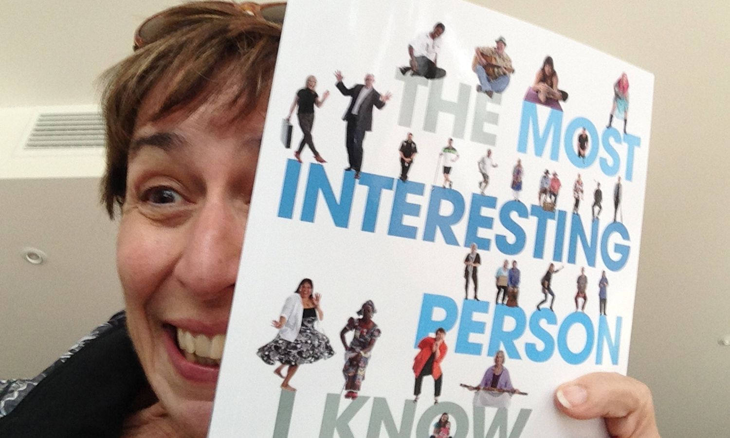 Writer holding the “Most Interesting Person I Know” publication, pride, joy in community storytelling initiative. Photos by Raymond Mather.