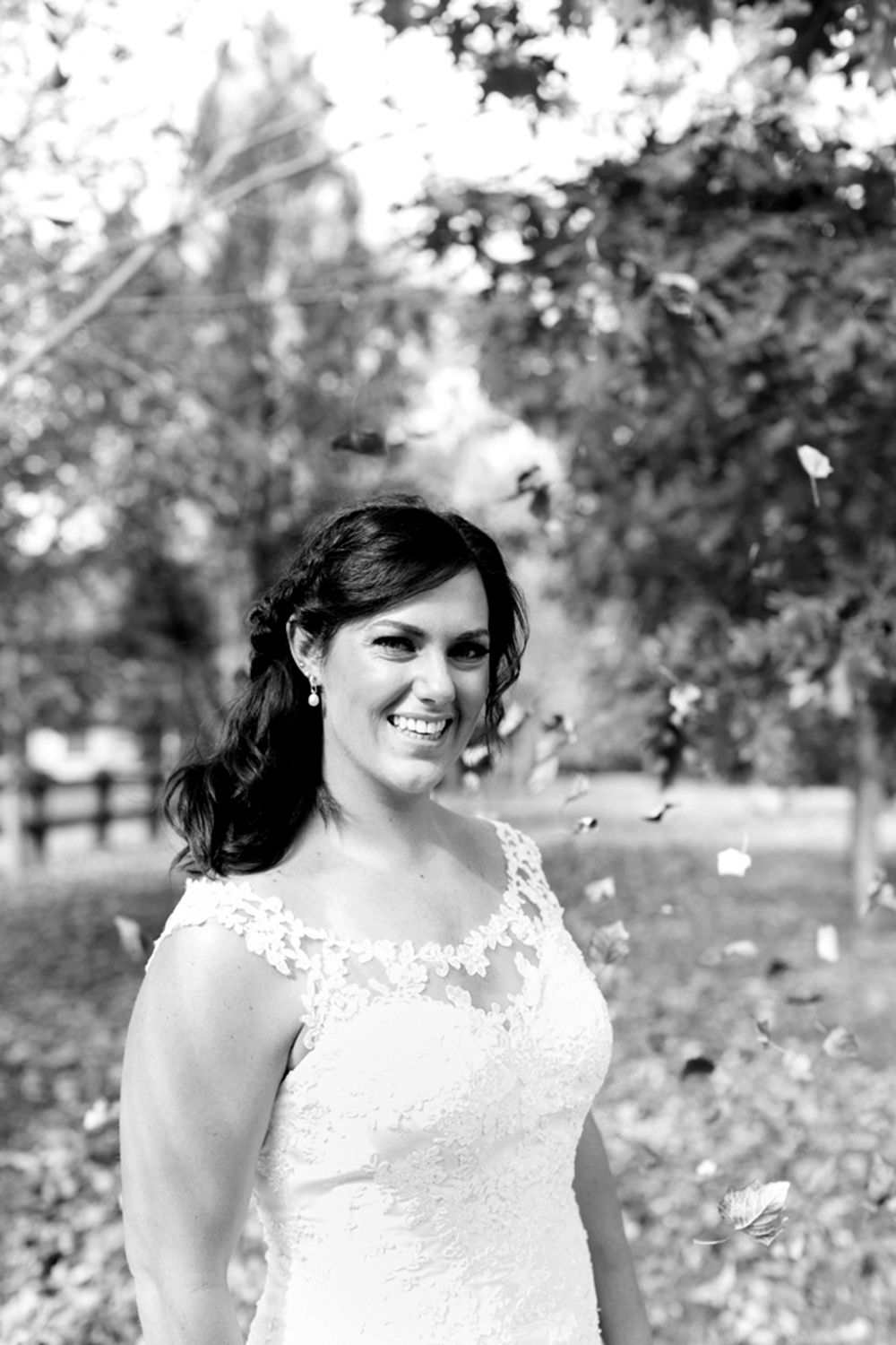 Black and white bridal portrait captured outdoors with natural light and gentle expression. Photo by Raymond Mather.