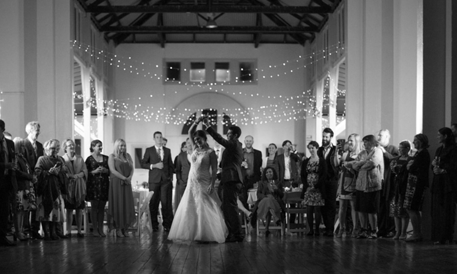 Monochrome version of the first dance, capturing timeless emotion and elegant movement. Photo by Raymond Mather.