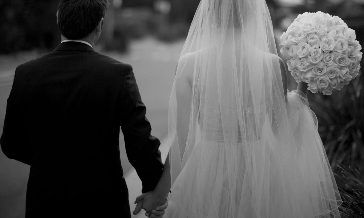 Black and white wedding photos show bride in flowing veil and groom in tuxedo during ceremony moments.