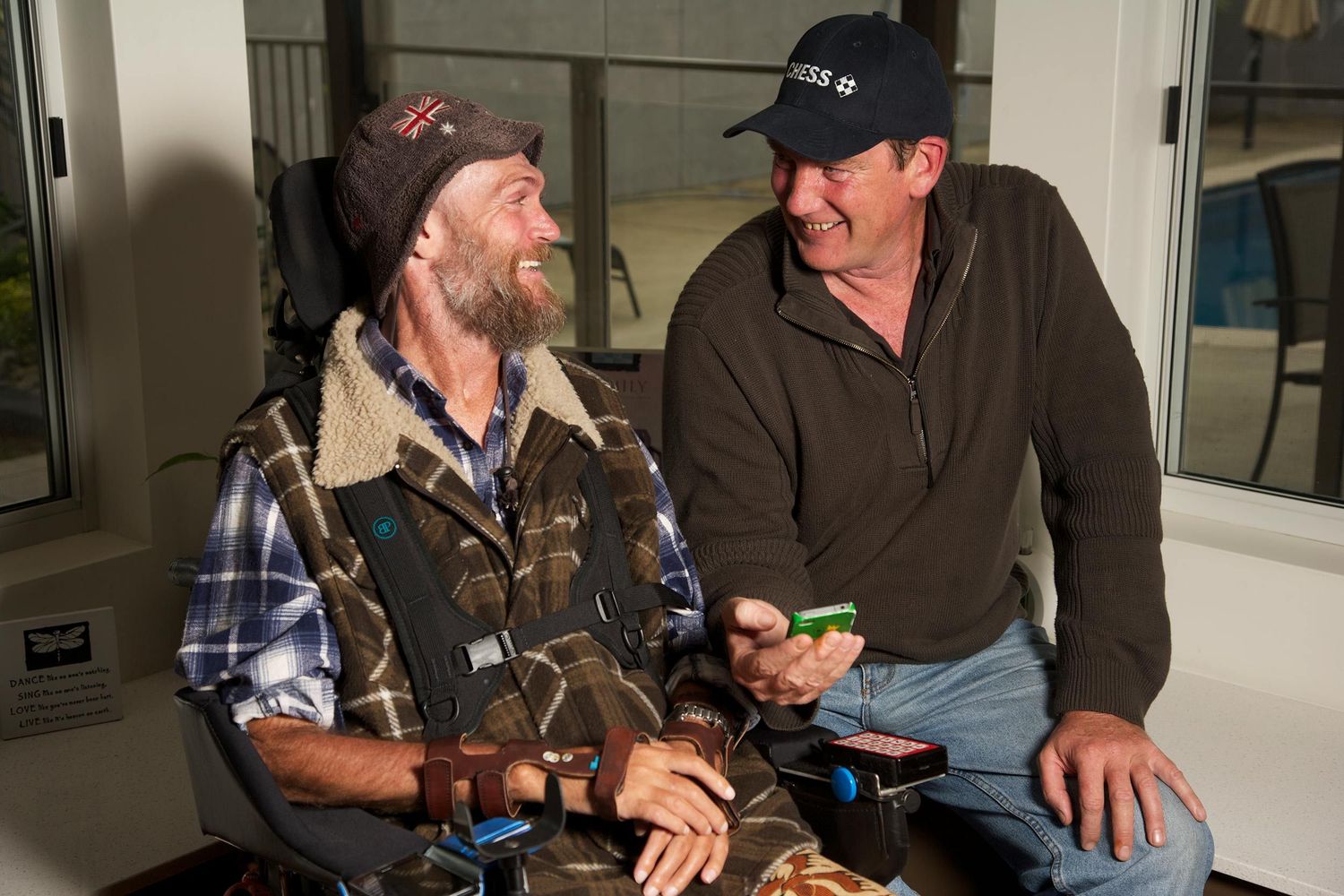 Colour portrait, two men sharing conversation and connection, a candid moment of trust, friendship, CHESS Services. Photo by Raymond Mather.