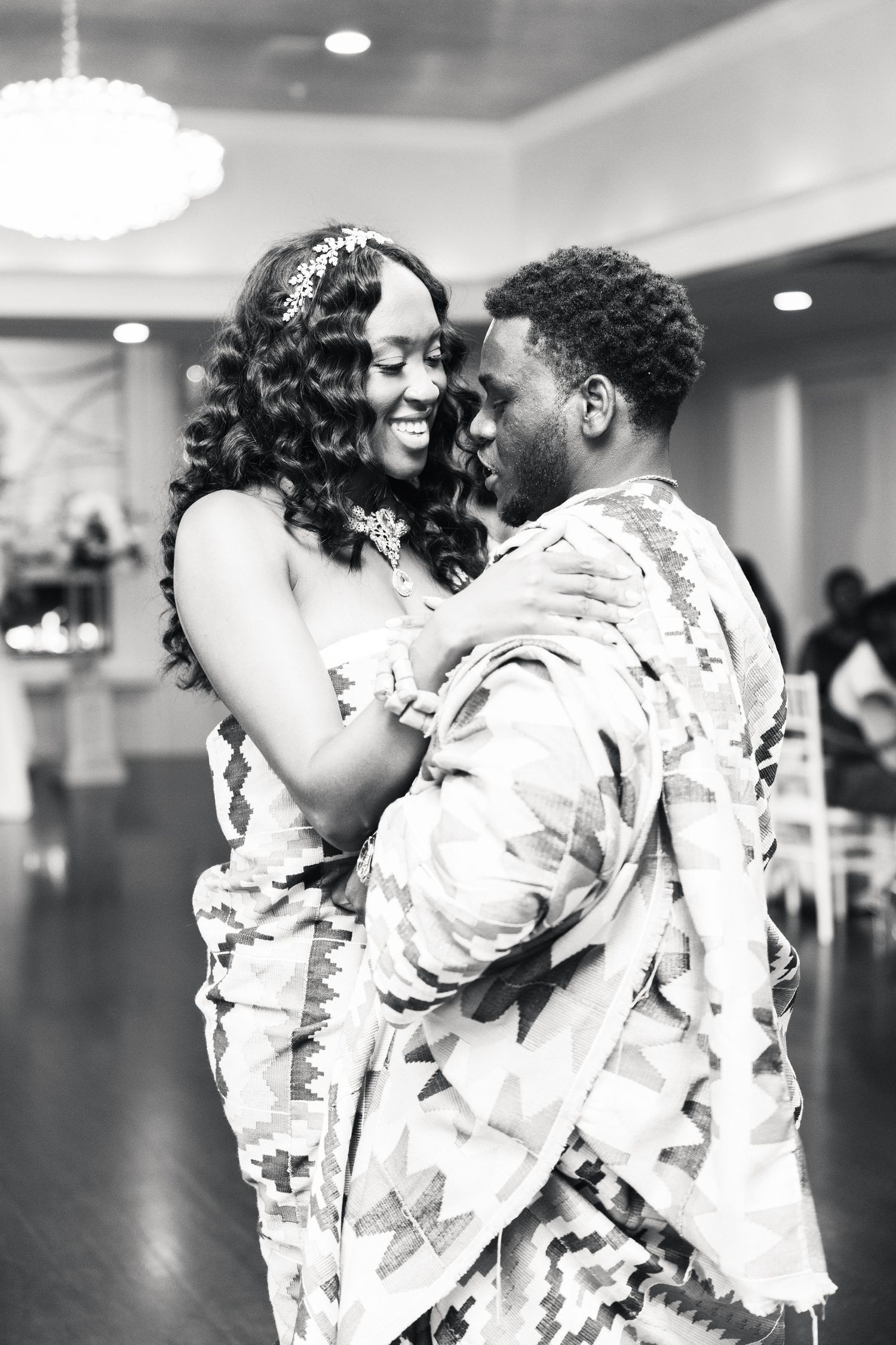 Black and white photo of a couple sharing a tender first dance at their wedding.