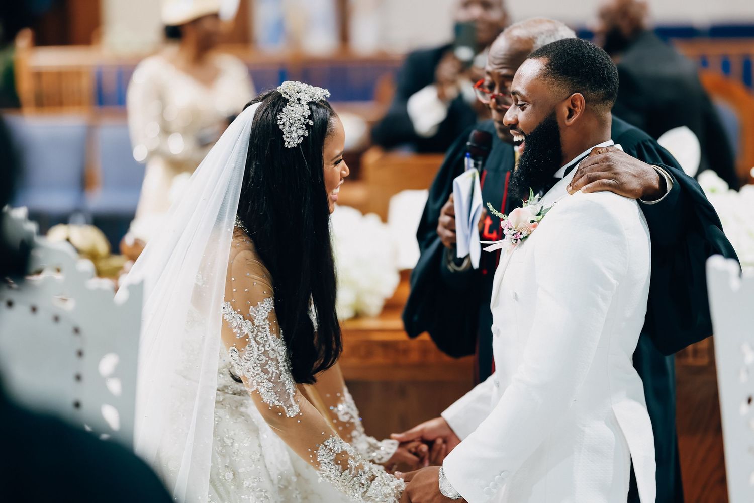 Bride and groom share a joyful moment at the altar during their elegant church wedding ceremony.