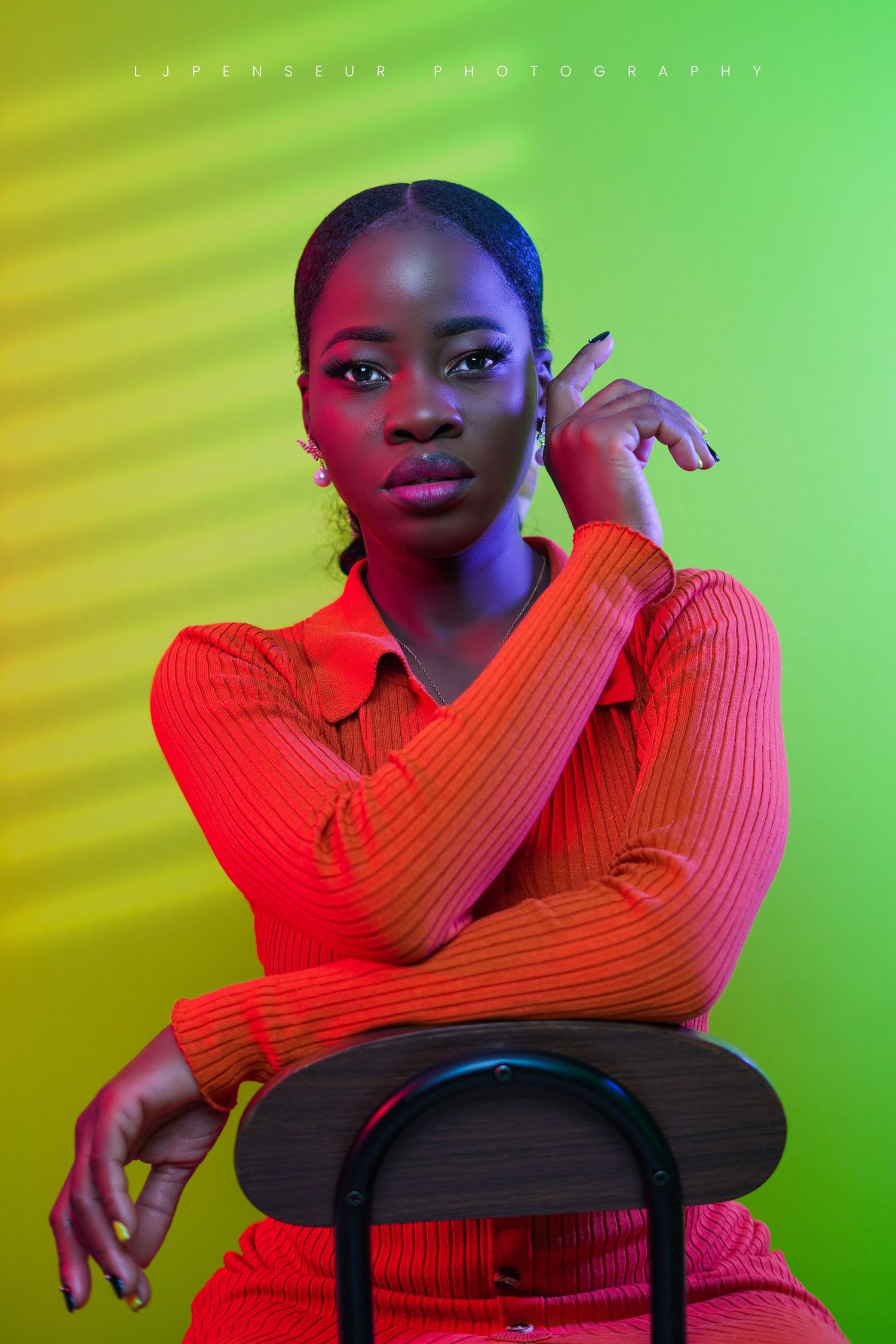 Creative portrait series in red ribbed top against vibrant green and yellow gradient background.