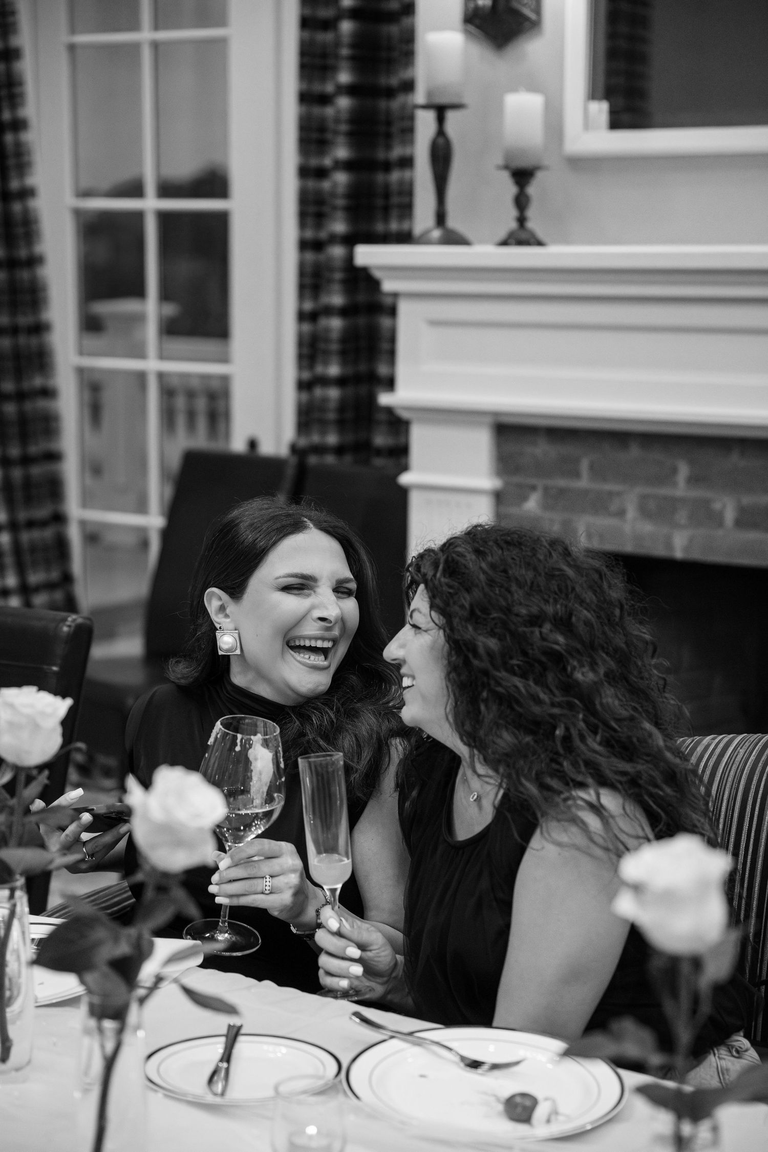 People enjoying drinks and conversation at an outdoor dinner party.