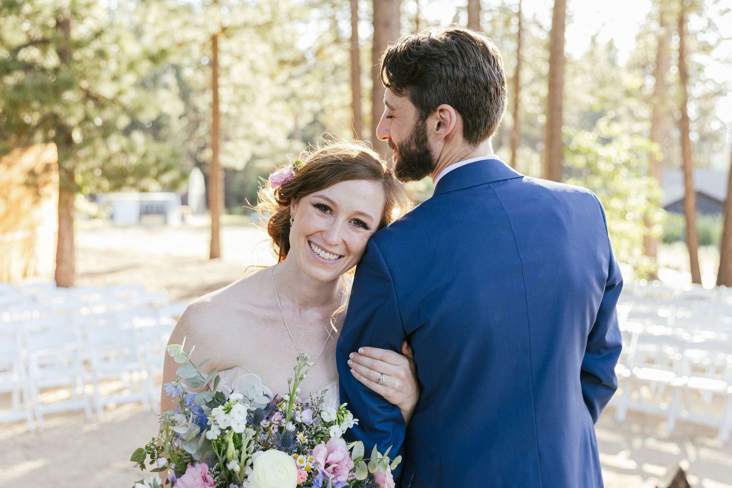 Candid moments of laughter and joy captured during outdoor wedding portraits.
