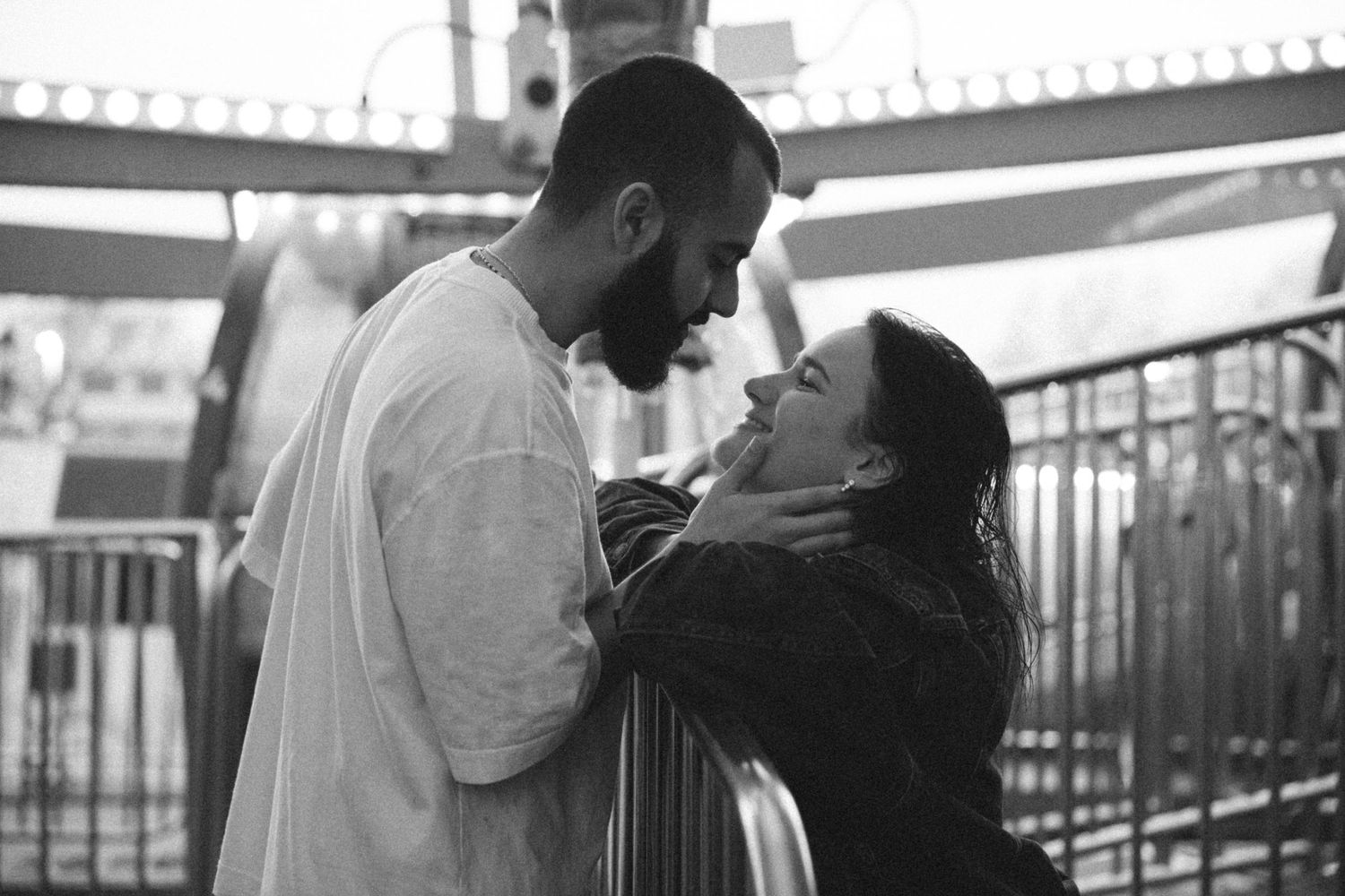 A series of romantic black and white photos showing tender moments at a carnival.