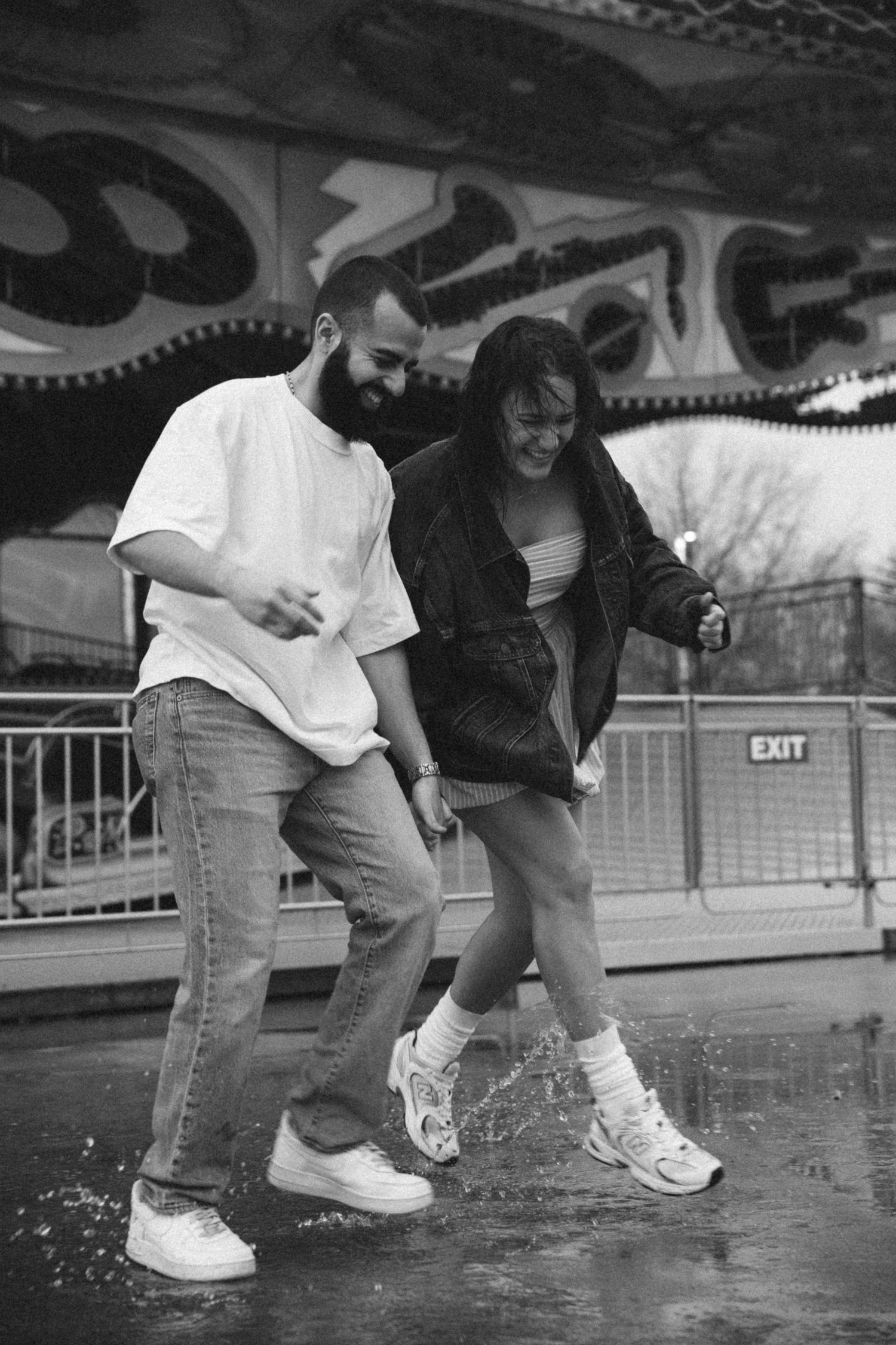Close-up shots of feet splashing in water on a wet boardwalk in black and white.
