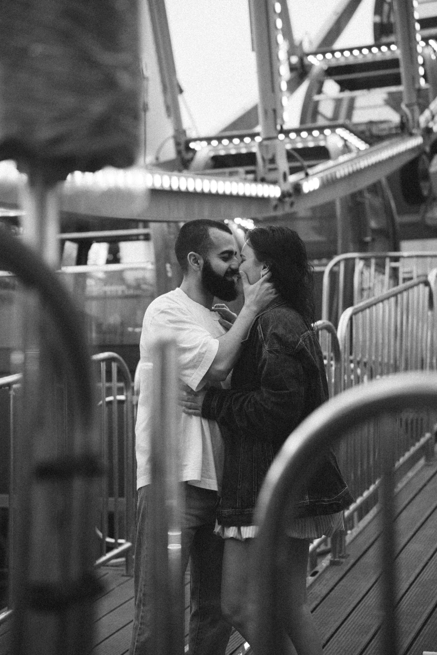 A romantic sequence captured at an amusement park showing tender moments between two people.