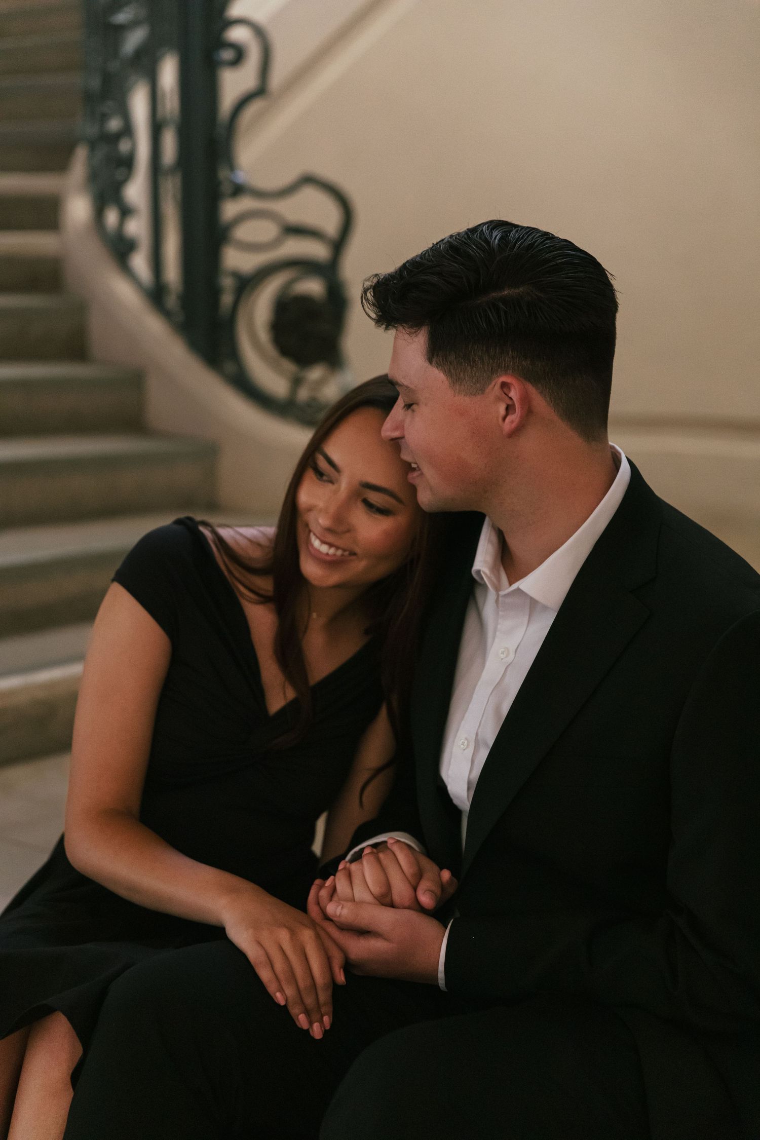An intimate engagement portrait session on mission steps with warm lighting.
