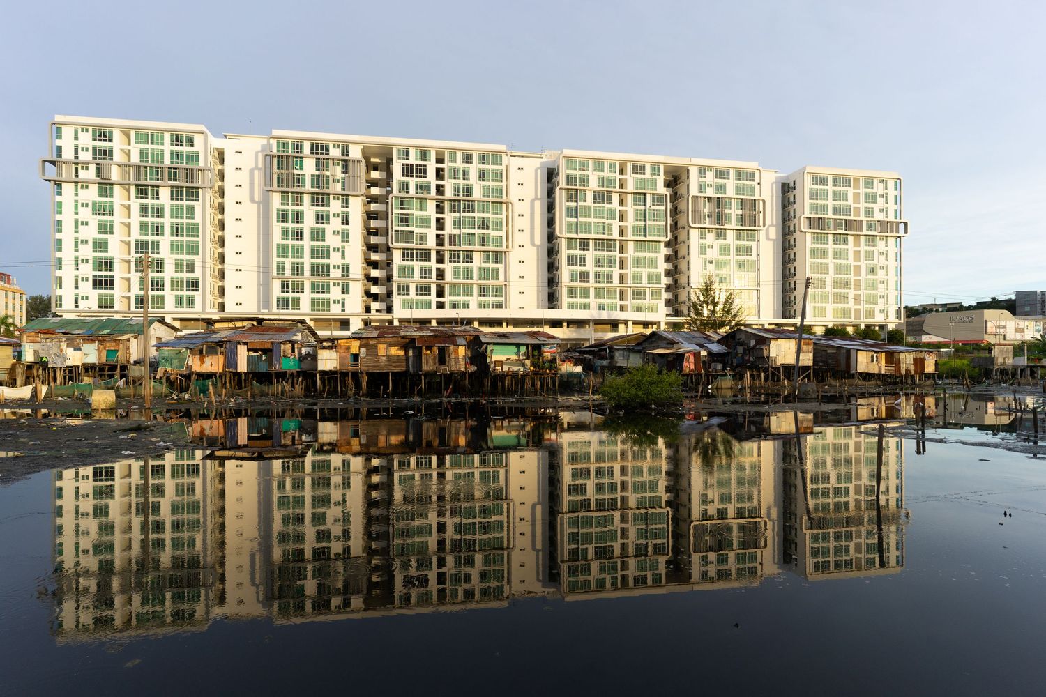 A juxtaposition view of Kampung Air Sembulan and the commercial buildings of Sutera Avenue