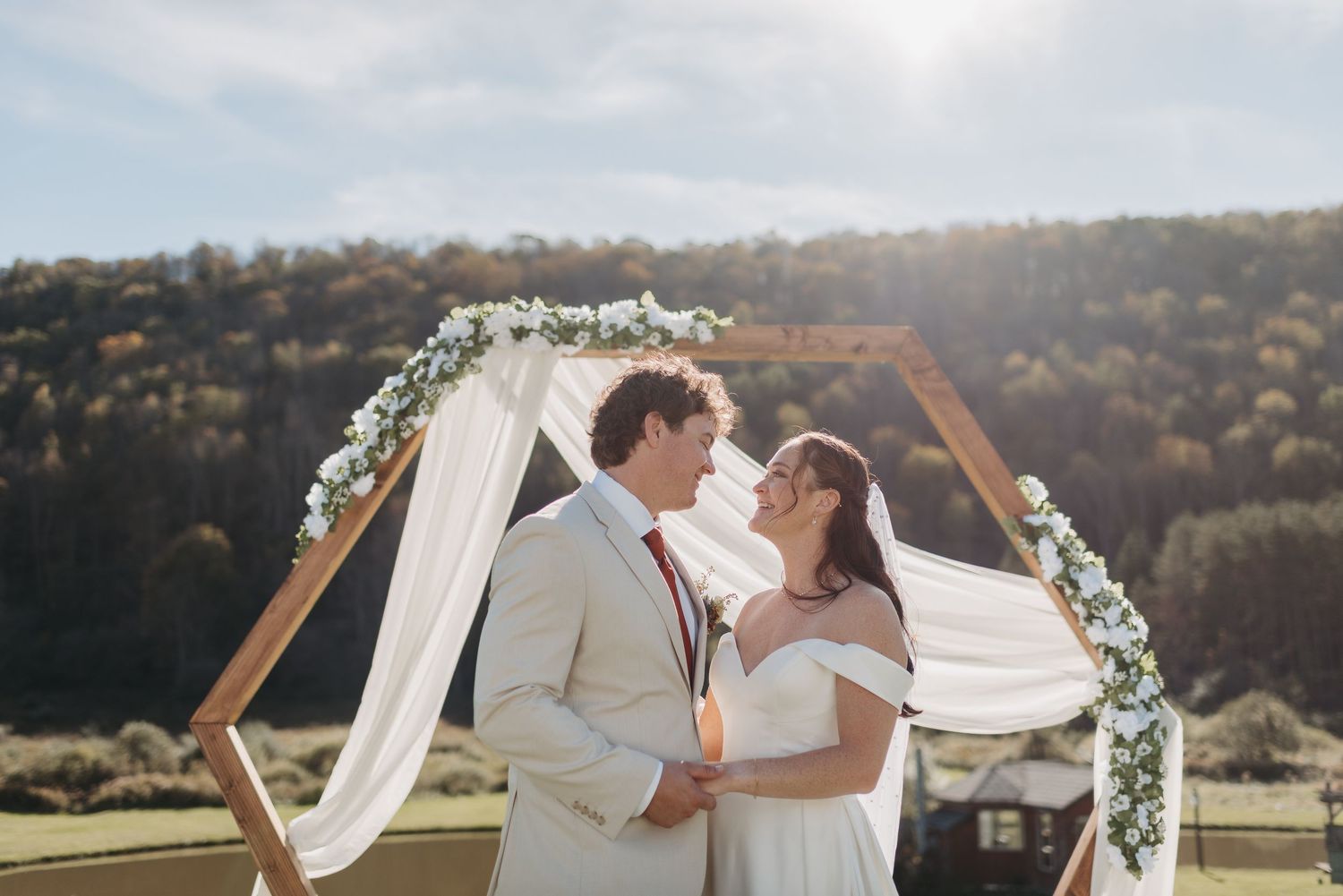 A series of romantic wedding photos showing couples embracing against scenic outdoor backdrops at sunset.