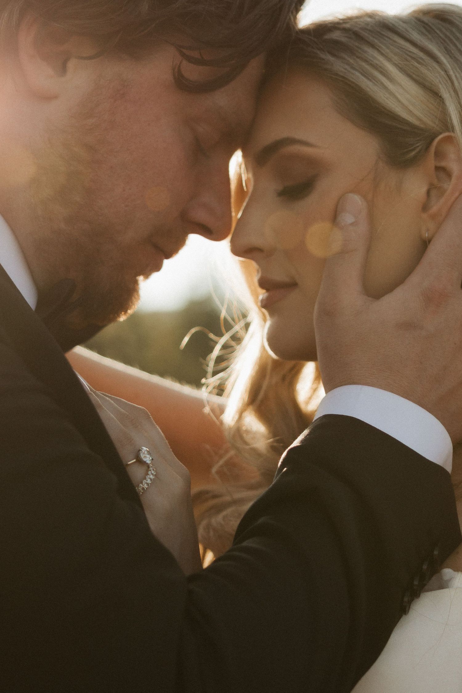 A romantic wedding photo sequence showing a couple in close embrace silhouetted against golden sunlight.