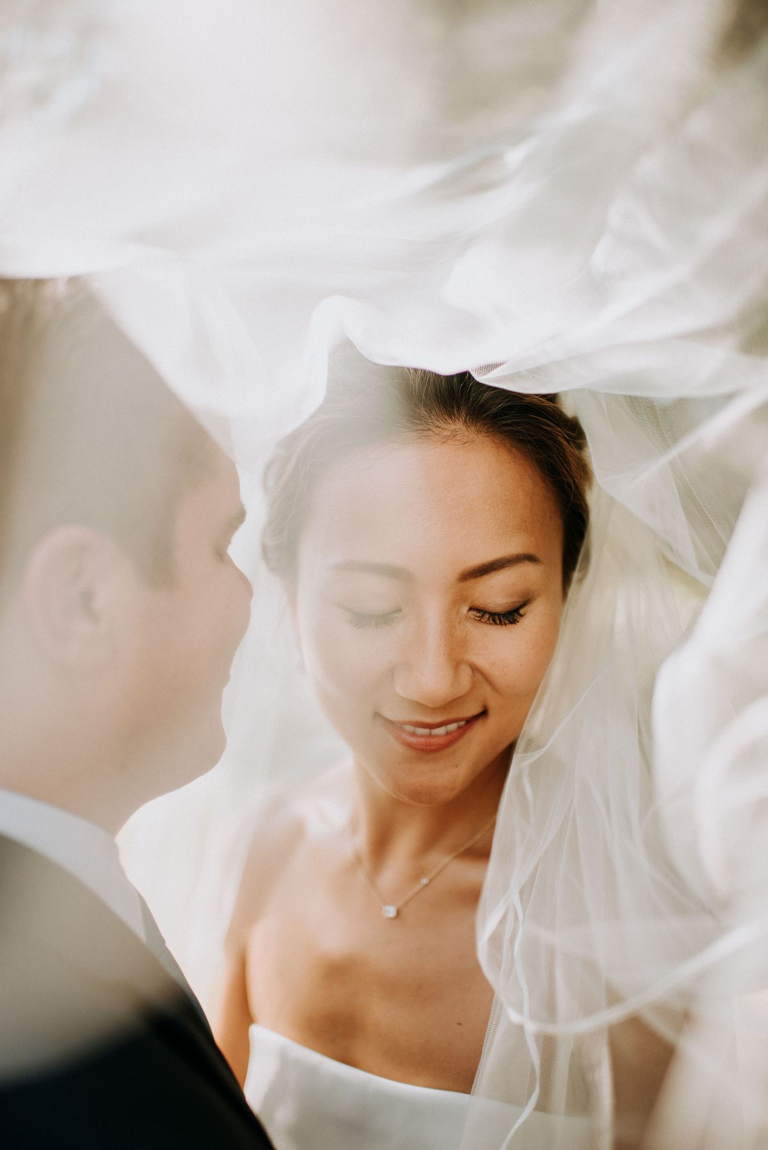 Ethereal bridal portrait series with flowing white veil creating a dreamy, romantic atmosphere.