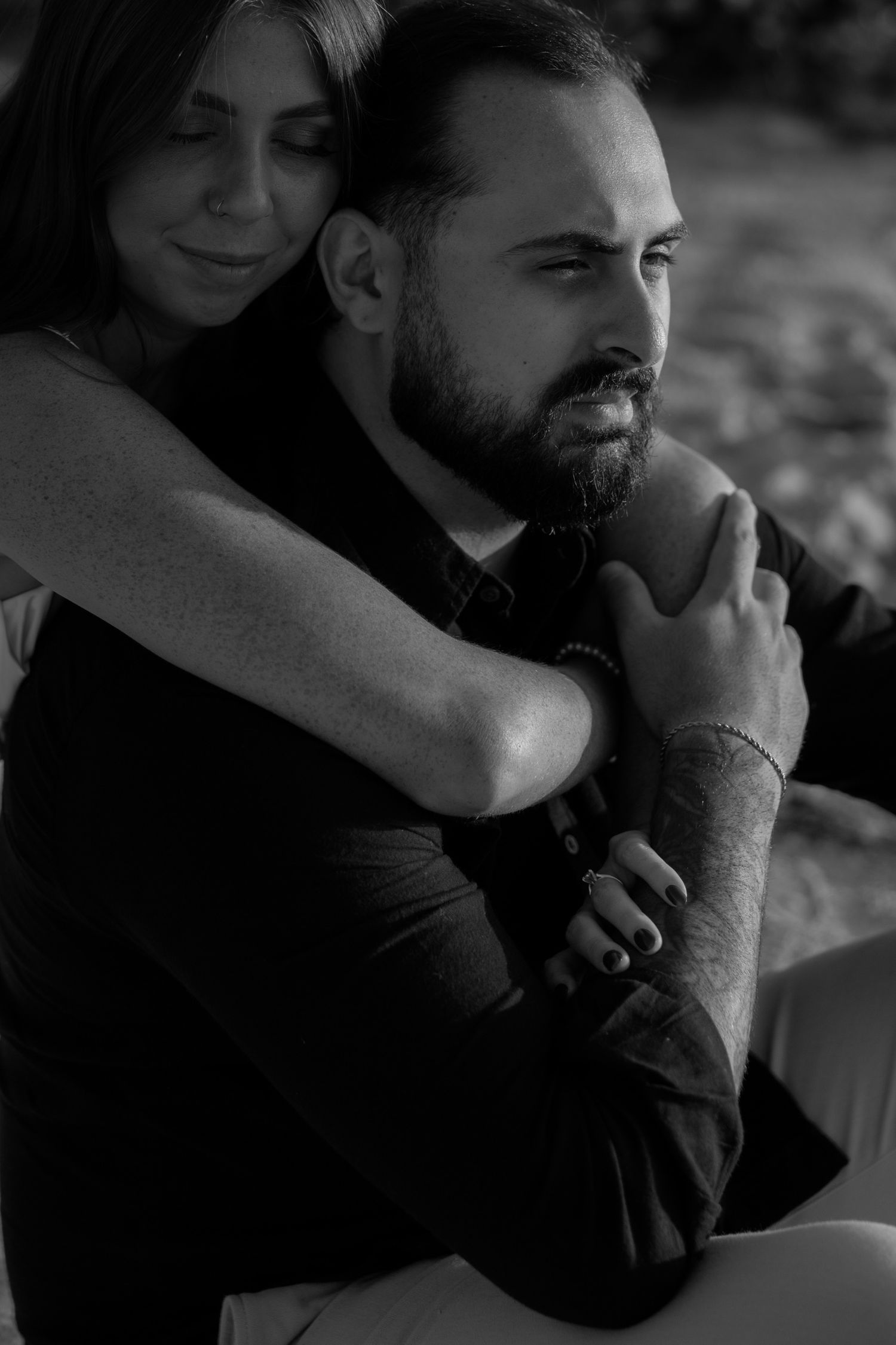 A romantic black and white photo series showing tender moments between a couple in close embrace.