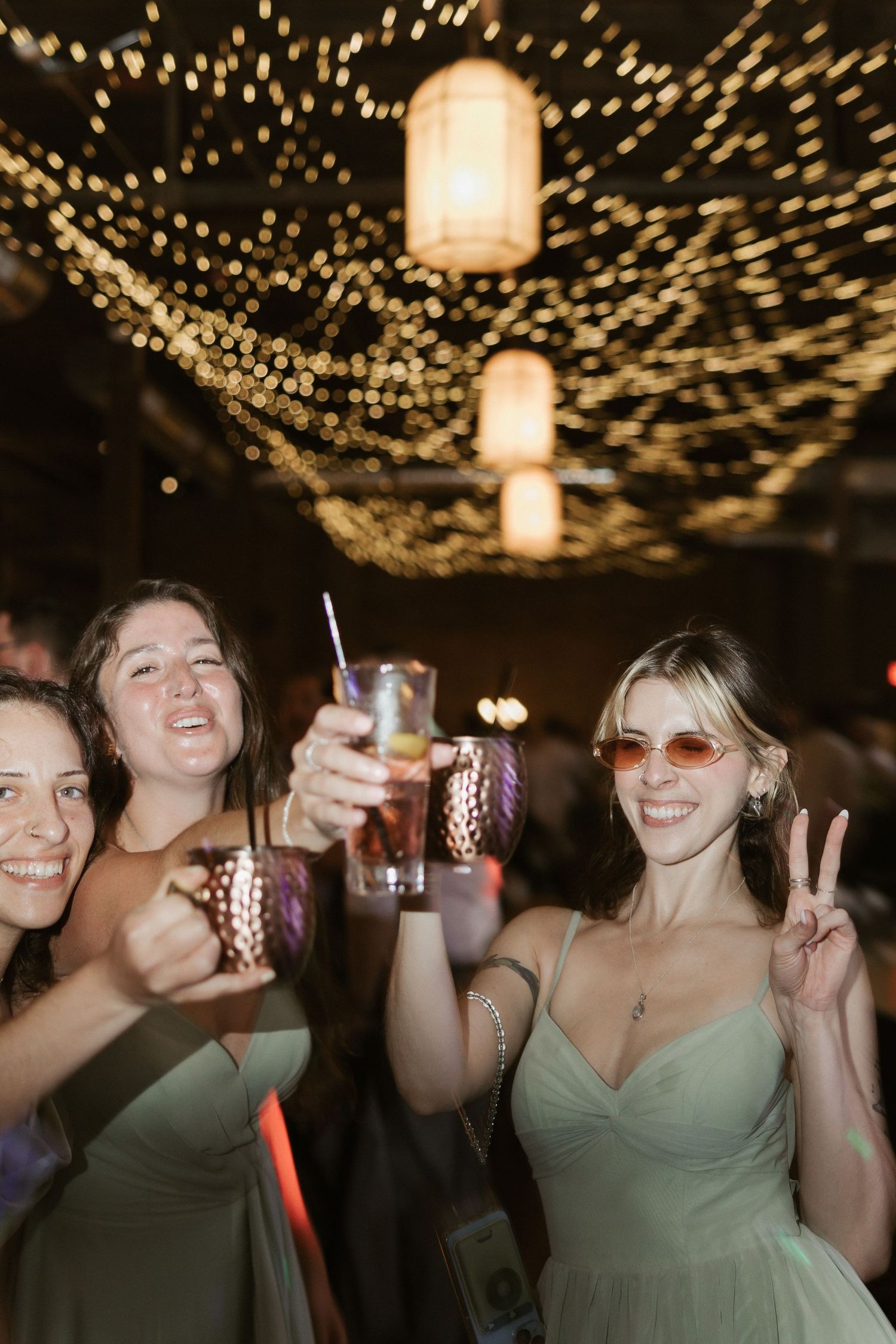 Party scene with string lights and paper lanterns creating magical ambiance at an evening celebration.