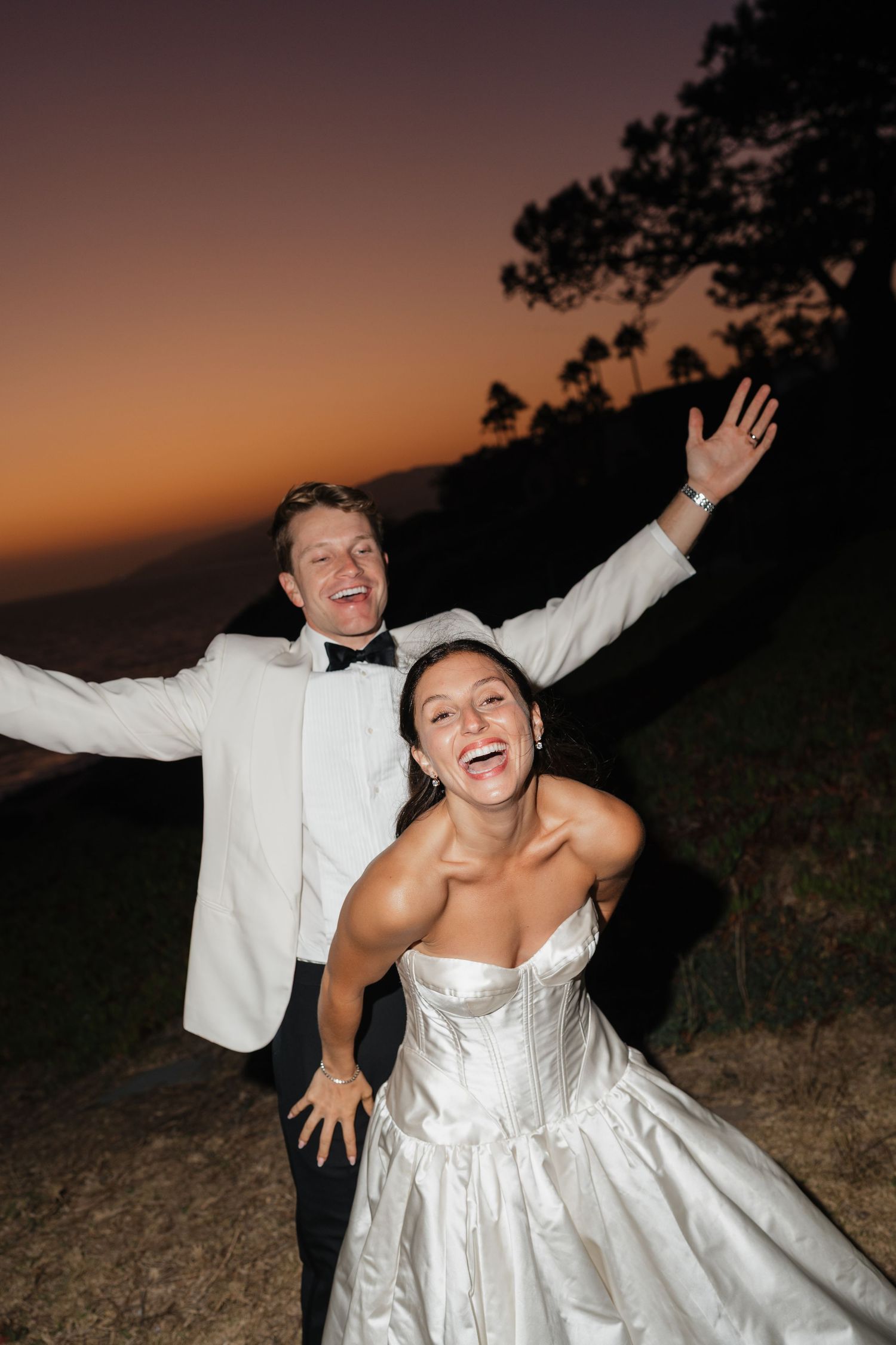 A couple in white wedding attire playfully poses at sunset in a series of candid shots.