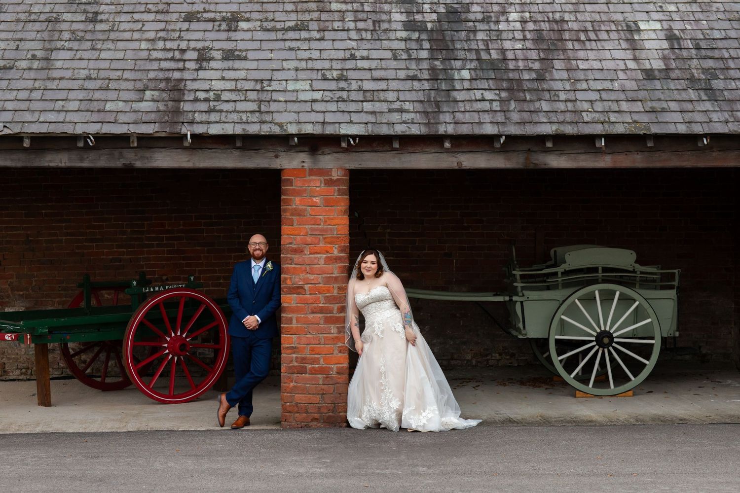 A rustic wedding photo collage showing vintage brick walls, wooden wagon wheels, and a bride's white dress against barn settings.