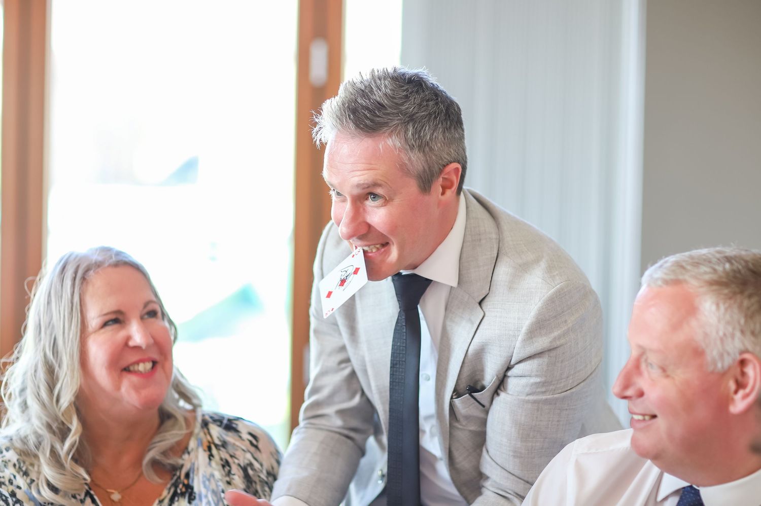 Wedding guests enjoying a lively conversation at a reception banquet table.