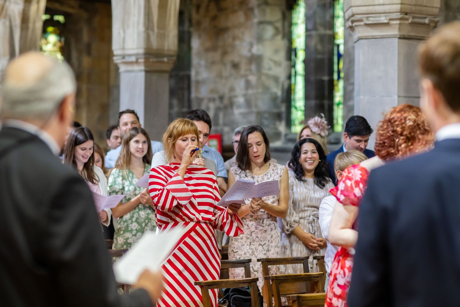 People gathered in a rustic stone venue for a celebratory event.