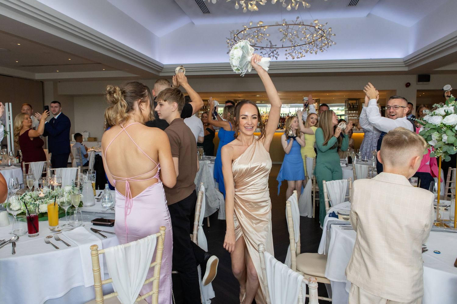 A series of wedding reception photos showing guests mingling and dancing in an elegant ballroom setting.