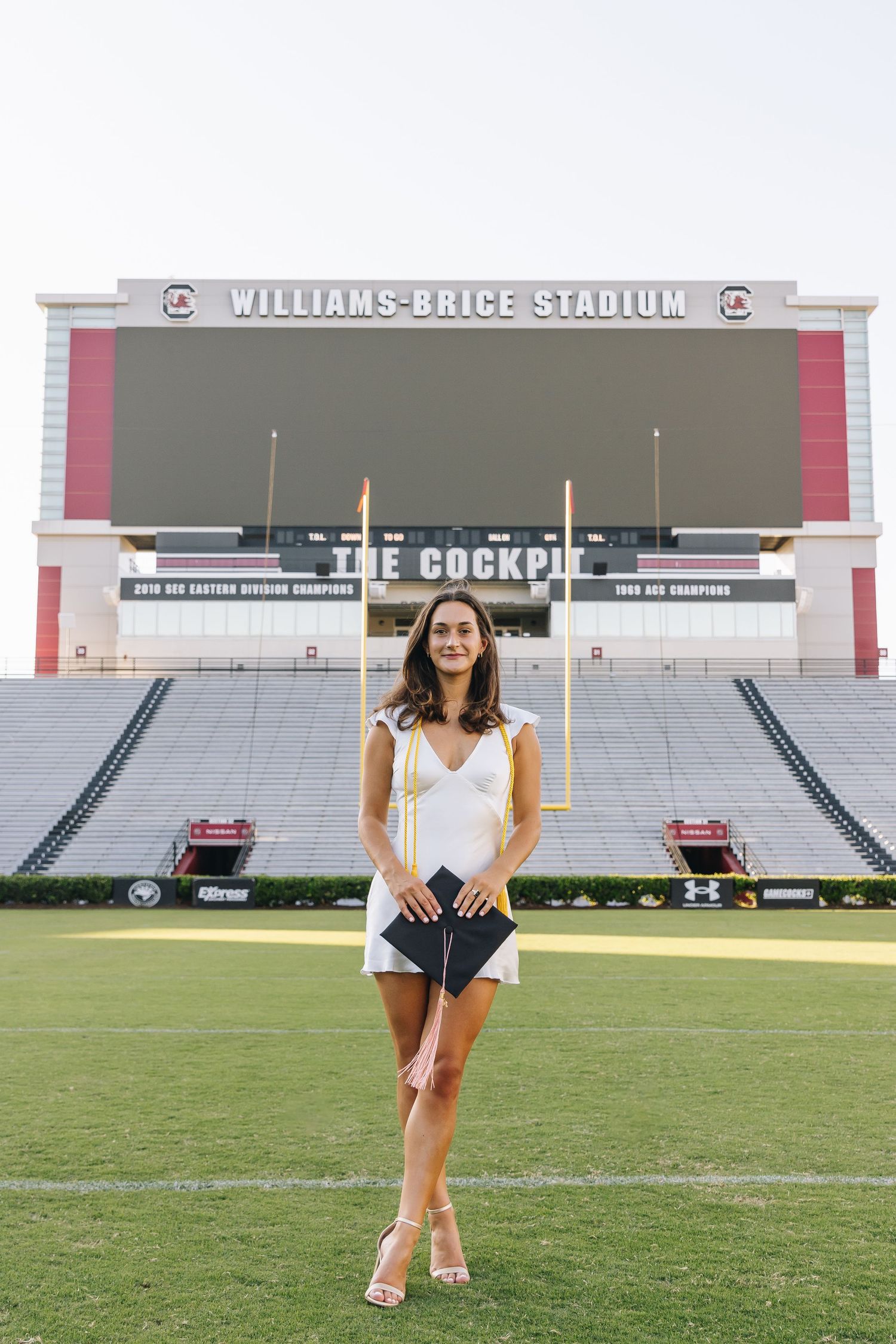 Stadium photo shoot at Williams-Brice Stadium with The Cockpit scoreboard visible.