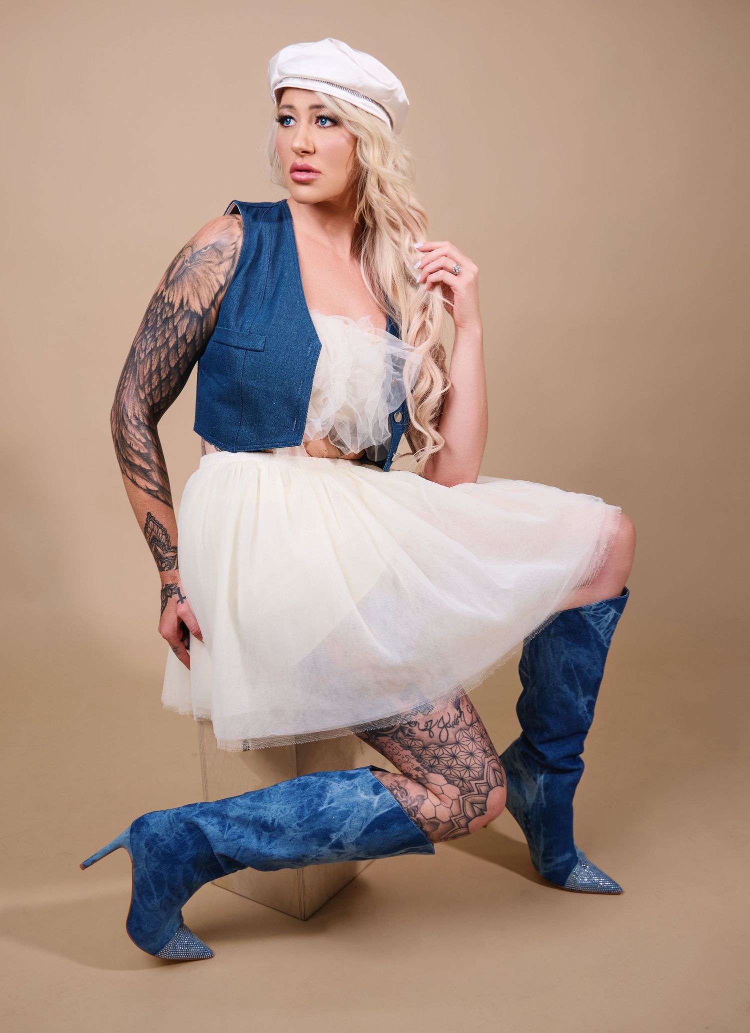 Artistic fashion portrait series in denim and white tulle against neutral beige backdrop with dynamic poses.