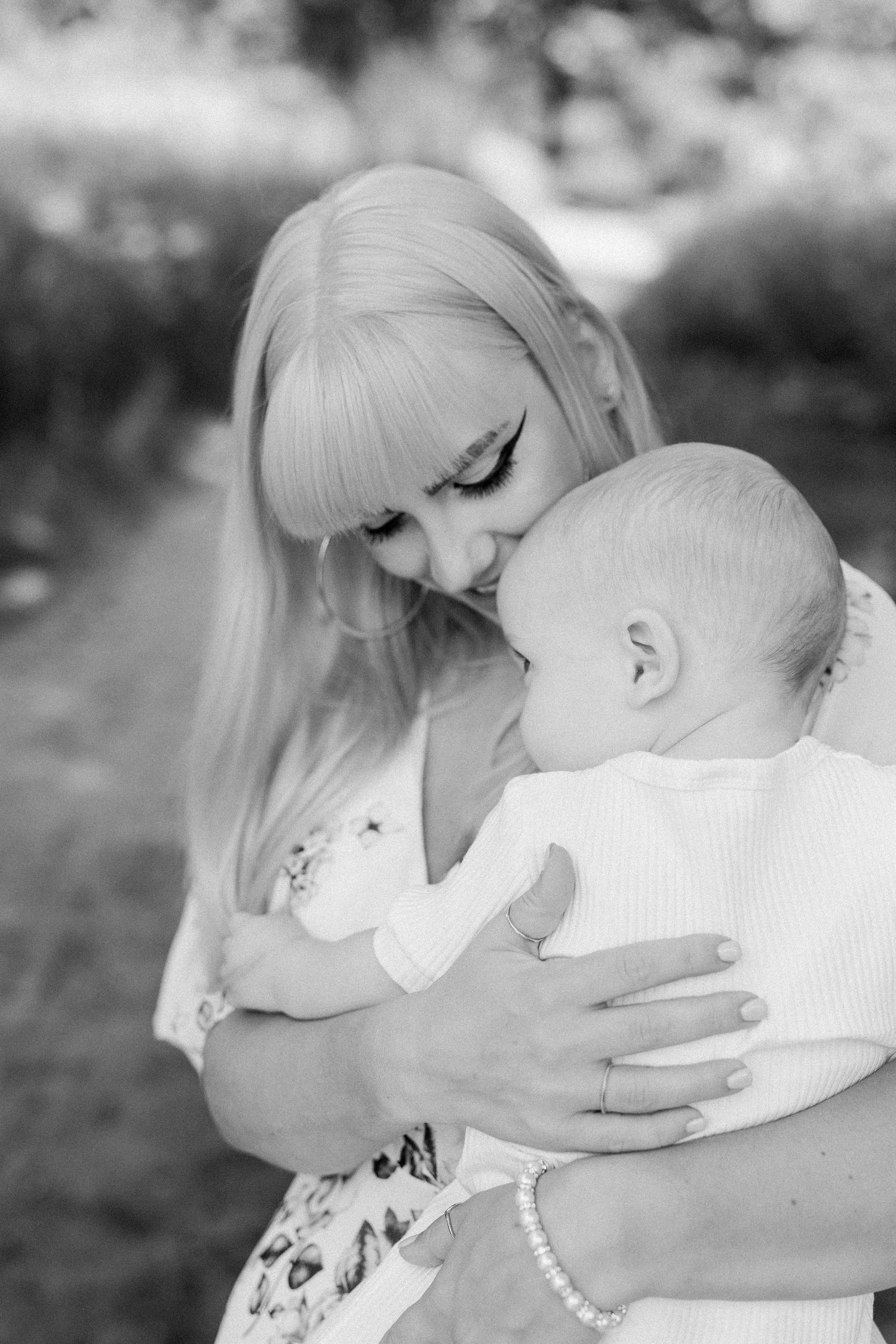 Tender black and white portrait of parent and child sharing an intimate moment.
