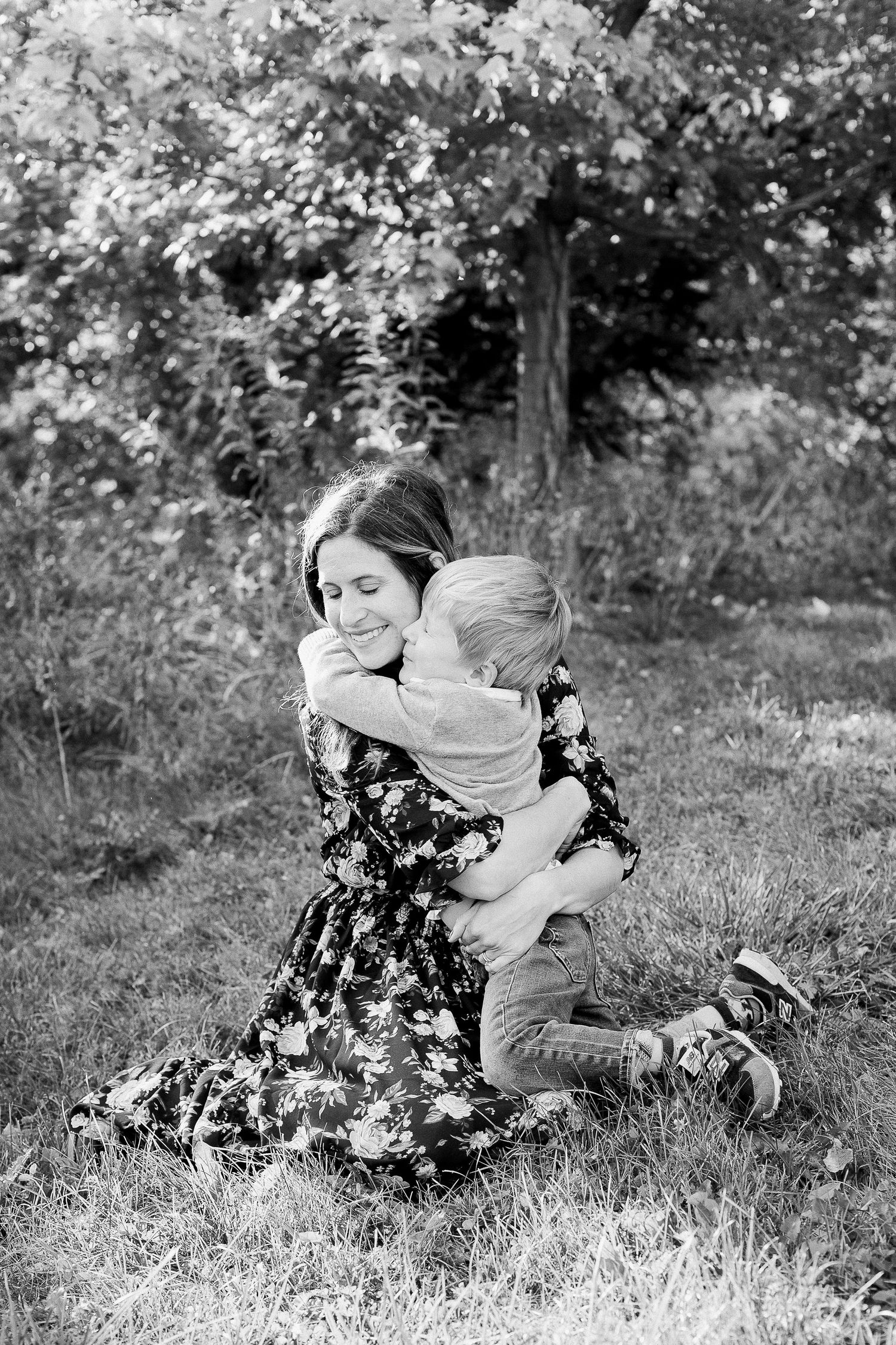 Black and white images of tender family moments in outdoor setting.