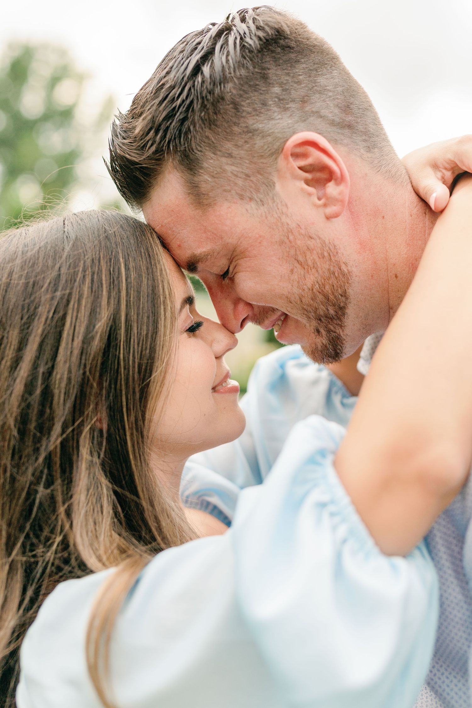 Close-up of couple sharing romantic moments in soft natural lighting.