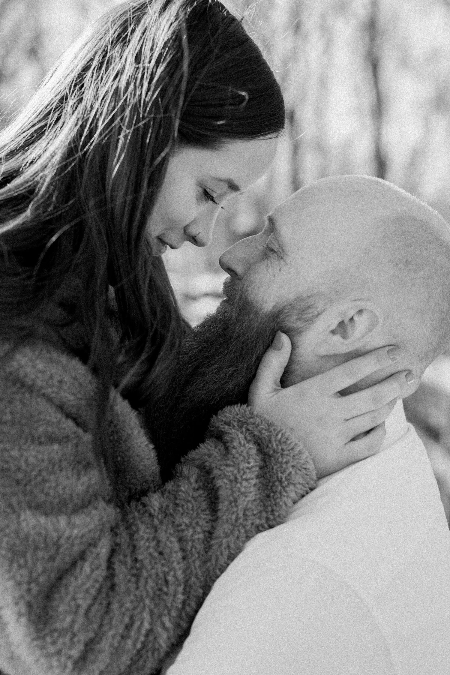 Black and white intimate portrait of couple sharing tender moments together.