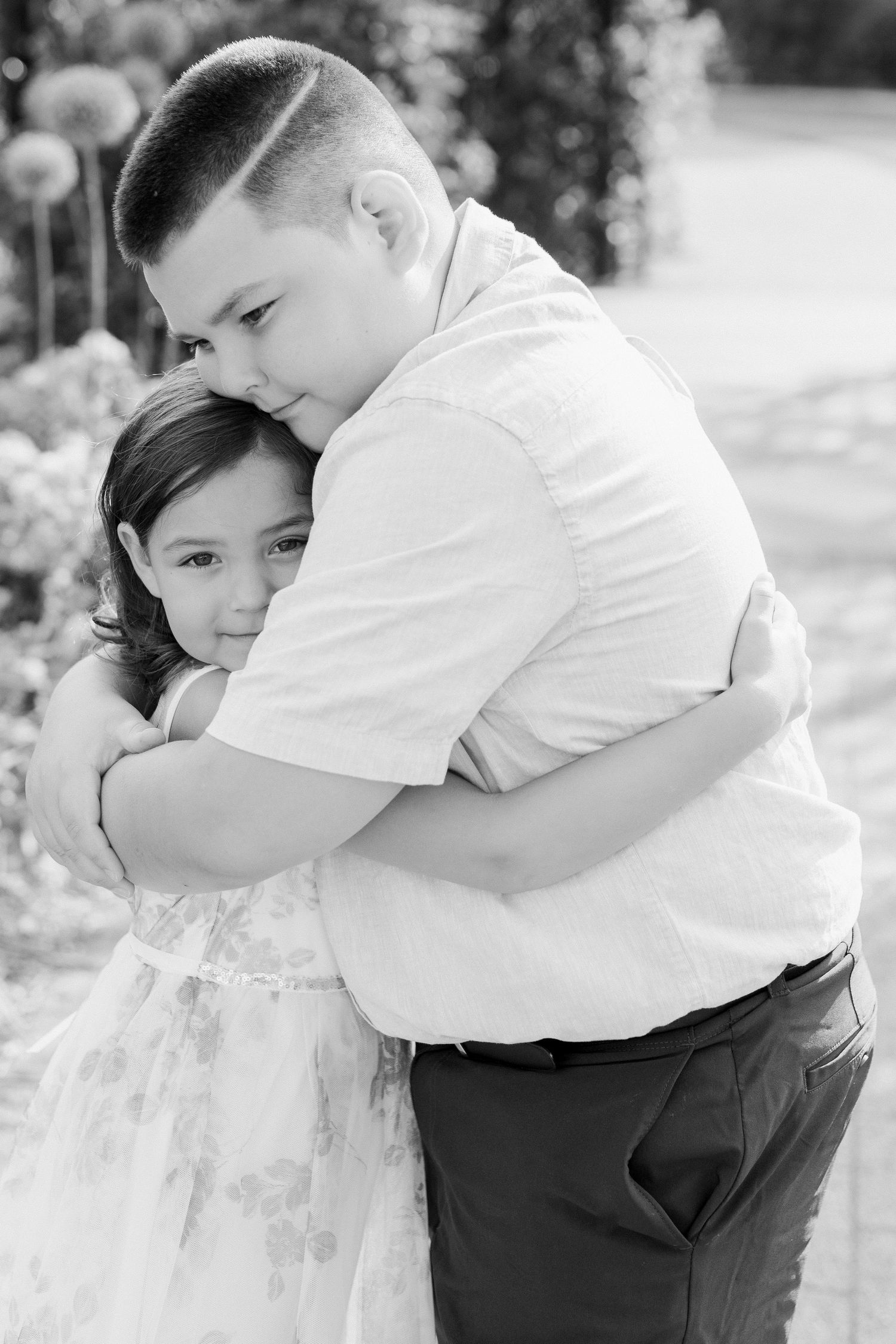 Black and white series of children hugging and showing affection.
