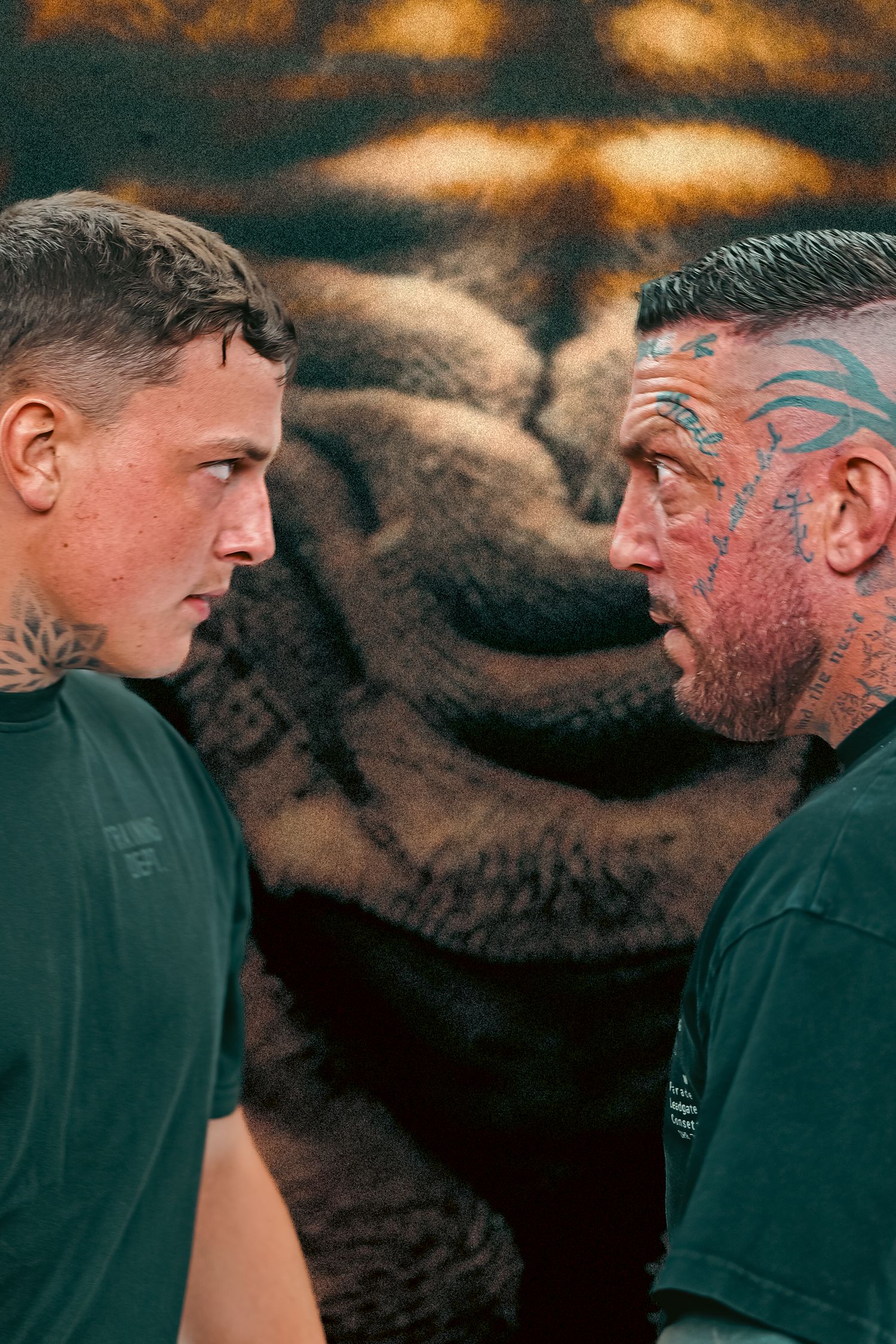 Two tattooed men in a tense face-off stance in front of a dramatic tiger street art mural.