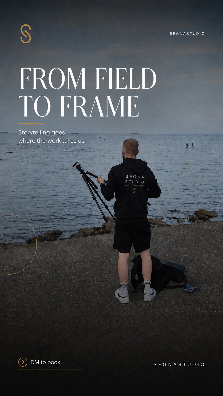 Segna Studio photographer standing on rocky shoreline with tripod capturing coastal storytelling content.