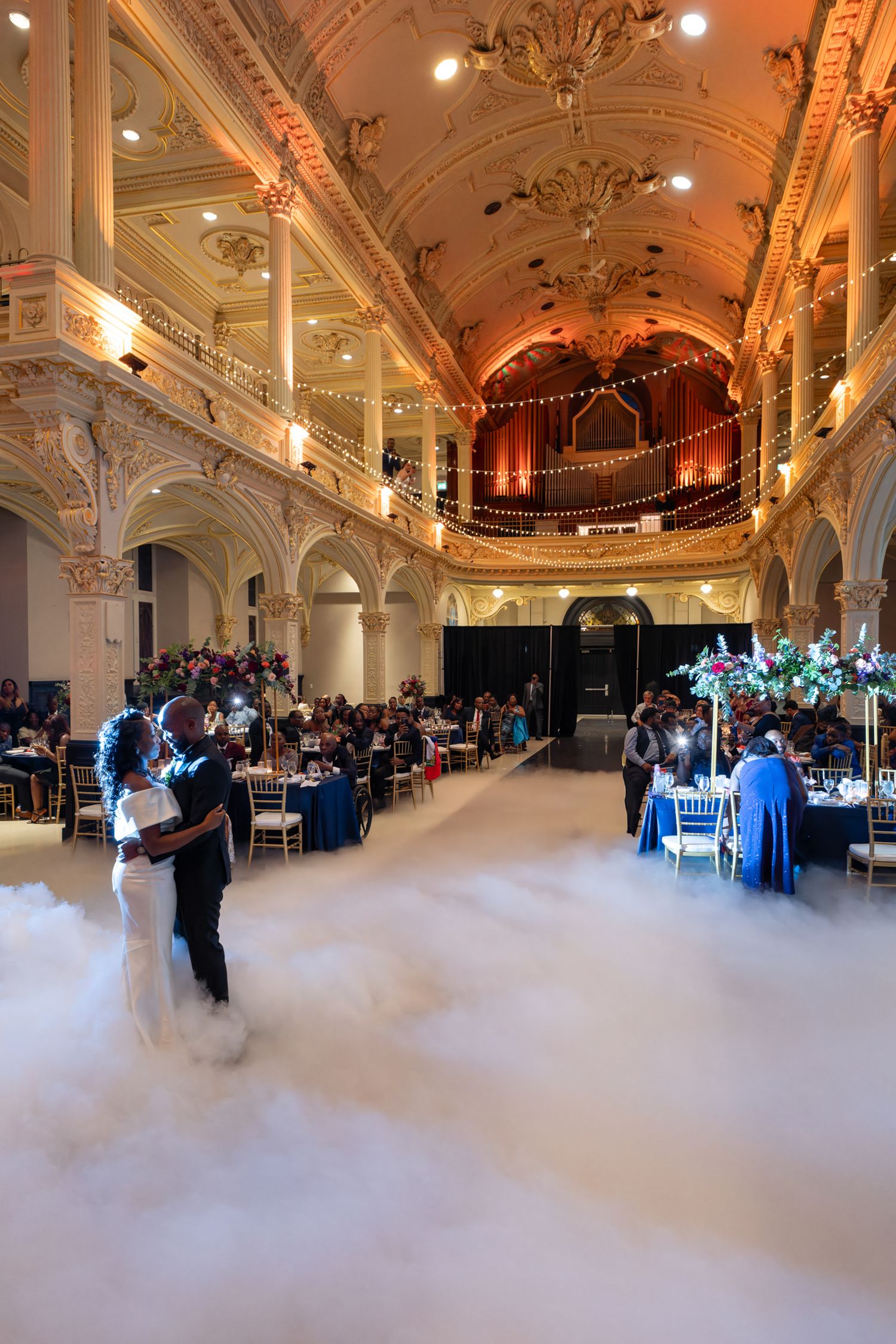 Wide shot of a grand reception ballroom with low-lying fog dance floor effect in Quebec