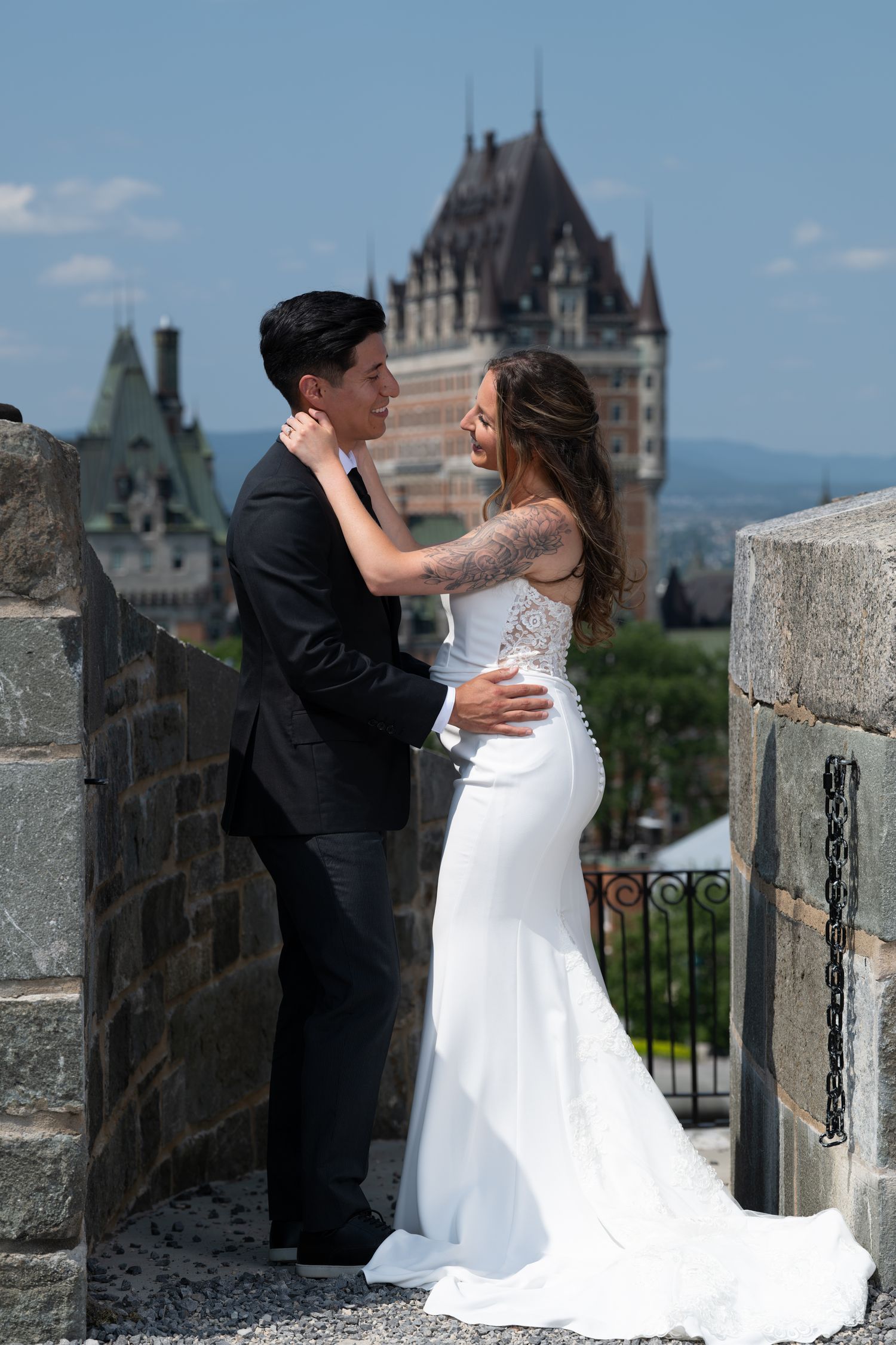 ride and groom embracing on a terrace with an iconic view of Château Frontenac in Old Quebec City