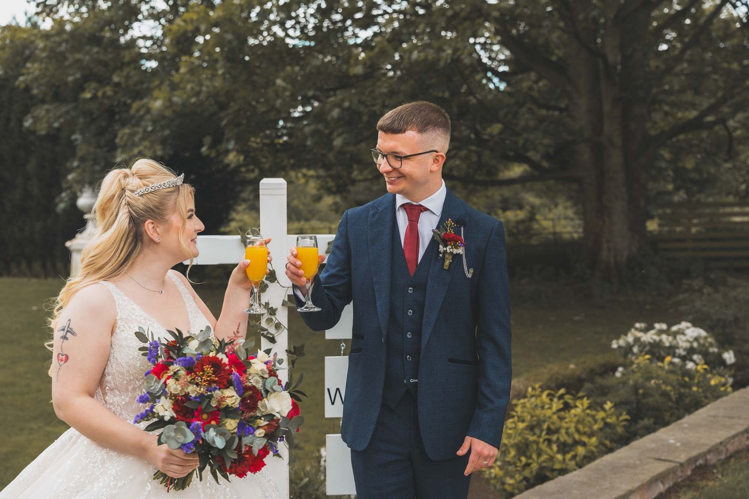 a bride and groom cheers their drinks at a wedding in south yorkshire